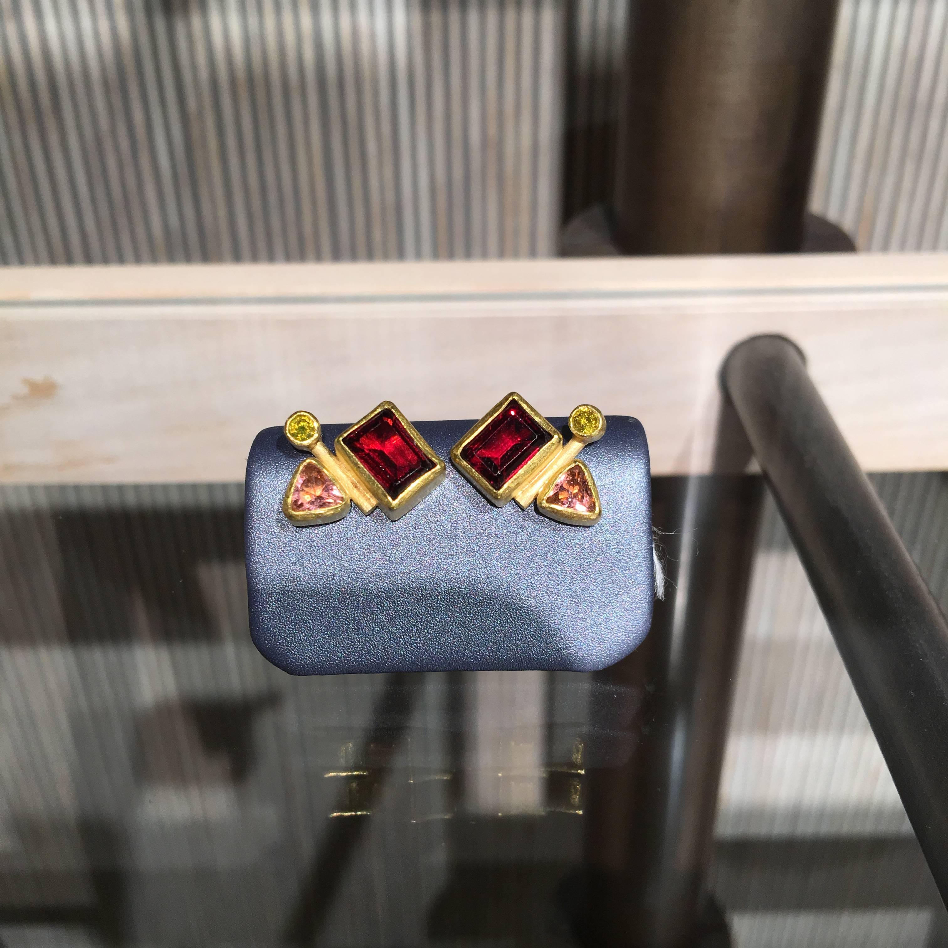 One of a Kind Multigemstone Abstract Stud Earrings handcrafted by jewelry artist Petra Class featuring matched pairs of round brilliant-cut canary diamonds, trillion-cut pink tourmaline, and emerald-cut garnets, all bezel-set in signature-finished