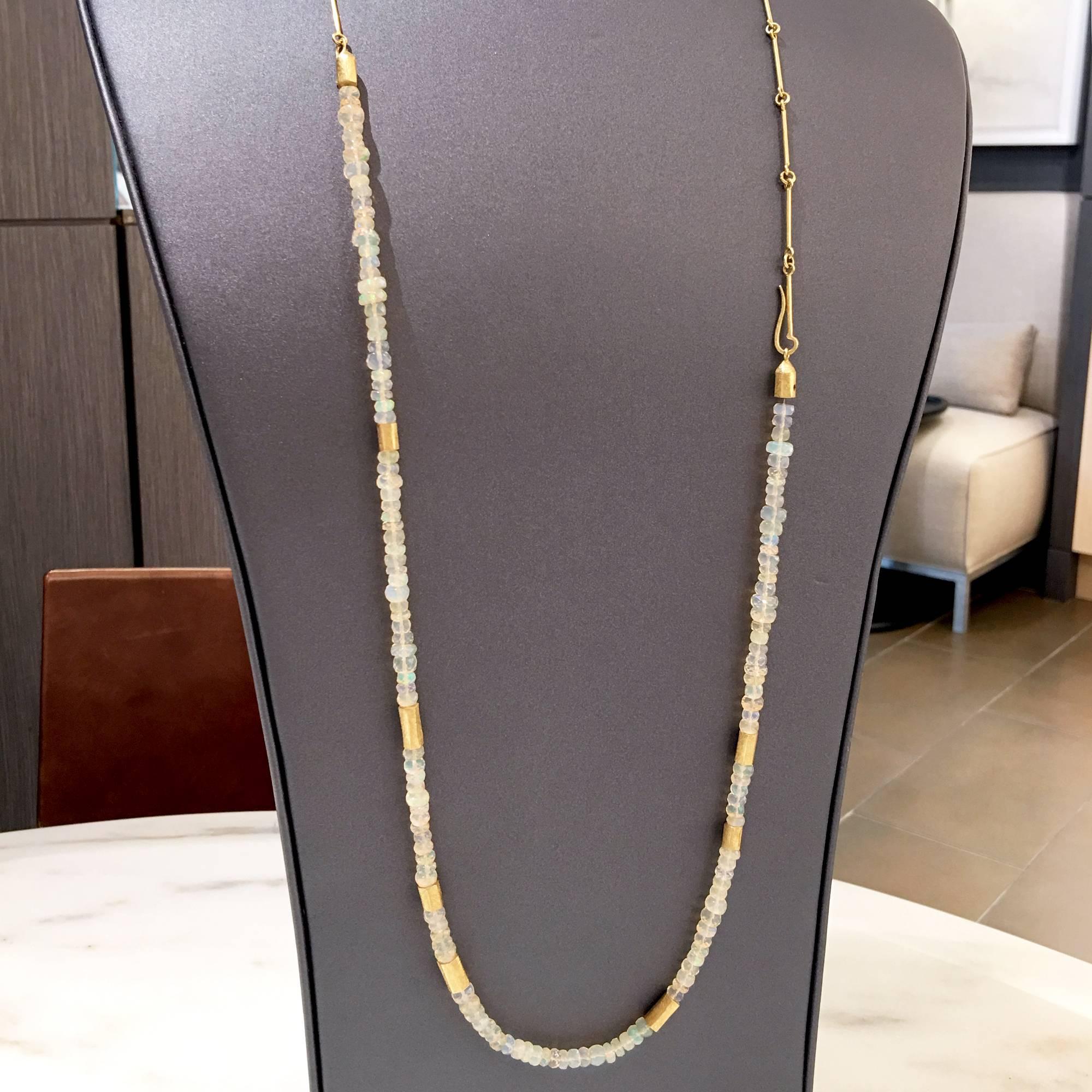 The possibilities are endless! This piece features two individual necklaces handcrafted by award-winning jewelry artist Petra Class in her signature-finished 18k yellow gold. The necklace showcases a strand of faceted Ethiopian opals separated by