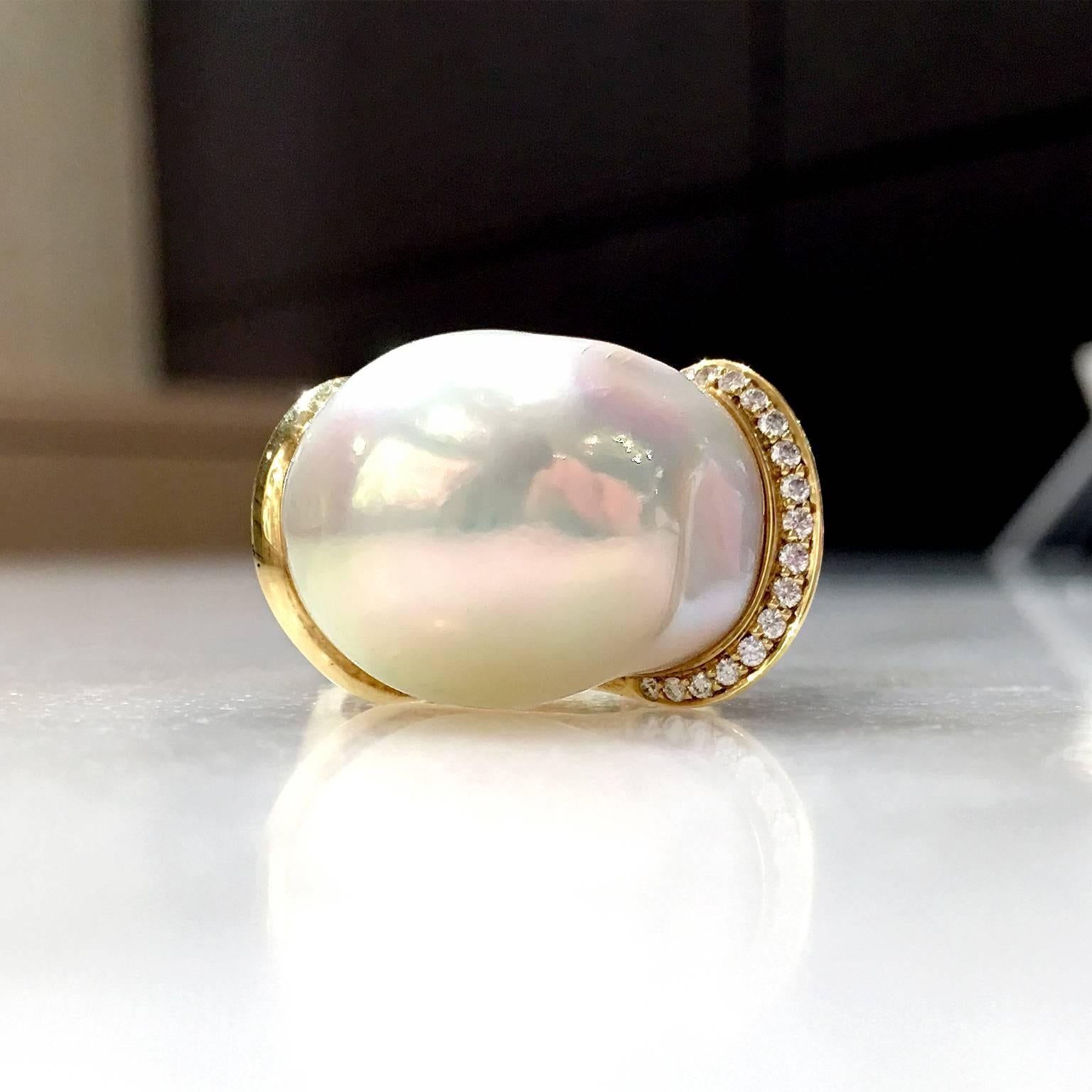One-of-a-Kind Diamond Curve Ring handcrafted in 18.5k yellow gold with a lustrous and colorful white freshwater pearl uniquely wrapped with 0.12 carats of F/vs1 round brilliant-cut white diamonds. Size 7.25 (Can be sized).

