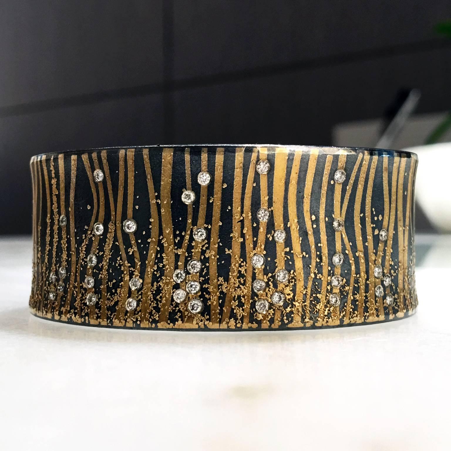 One of a Kind Narrow Cuff by internationally acclaimed jewelry studio Atelier Zobel and artist Peter Schmid, handcrafted in 24k gold and oxidized sterling silver with bezel-set round brilliant-cut diamonds totaling 0.39 carats. 1 in. opening
