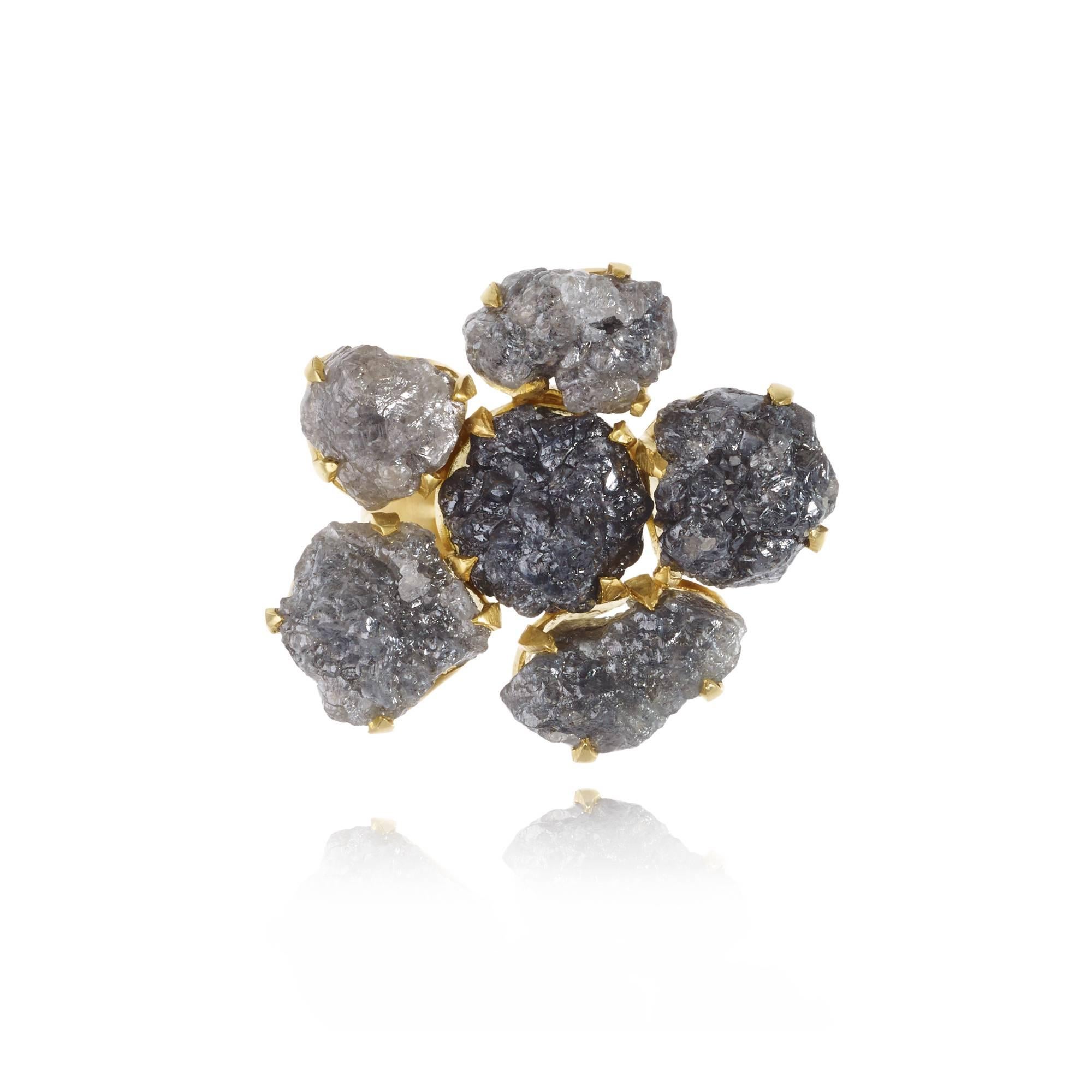 Evoking a quiet glamour of another era, the invisible collection combines the earthiness of uncut stones with the allure of sparkle. Differing from Pippa's traditional colette setting, each rough Diamond featured in this ring is held by a delicate