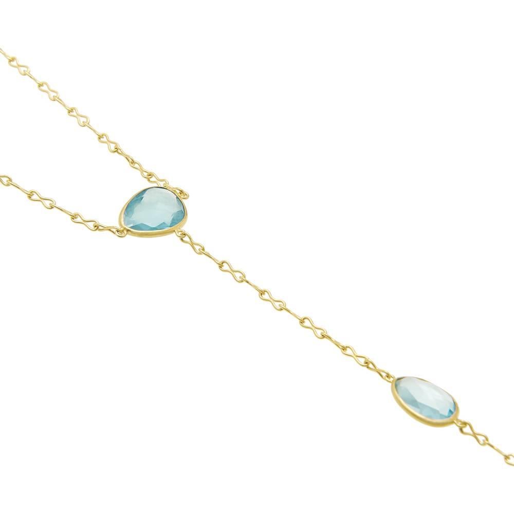 Inspired by a classic Indian style, a bracelet is joined by a delicate chain to a ring. Embellished with Aquamarine, this is a striking, yet subtle piece.

Bracelet: 7