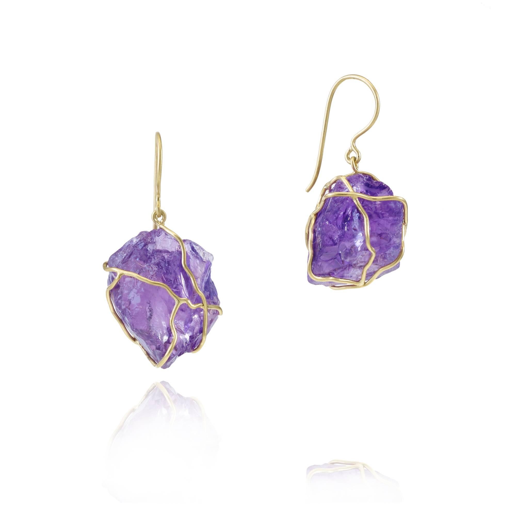 Inspired by the beauty of nature, these beautiful single drop earrings feature a lustrous, uncut Amethyst encased in an 18 Kt Gold wrap setting. Reminiscent of the woven spectacle that is the spiders web, they are the perfect statement piece.