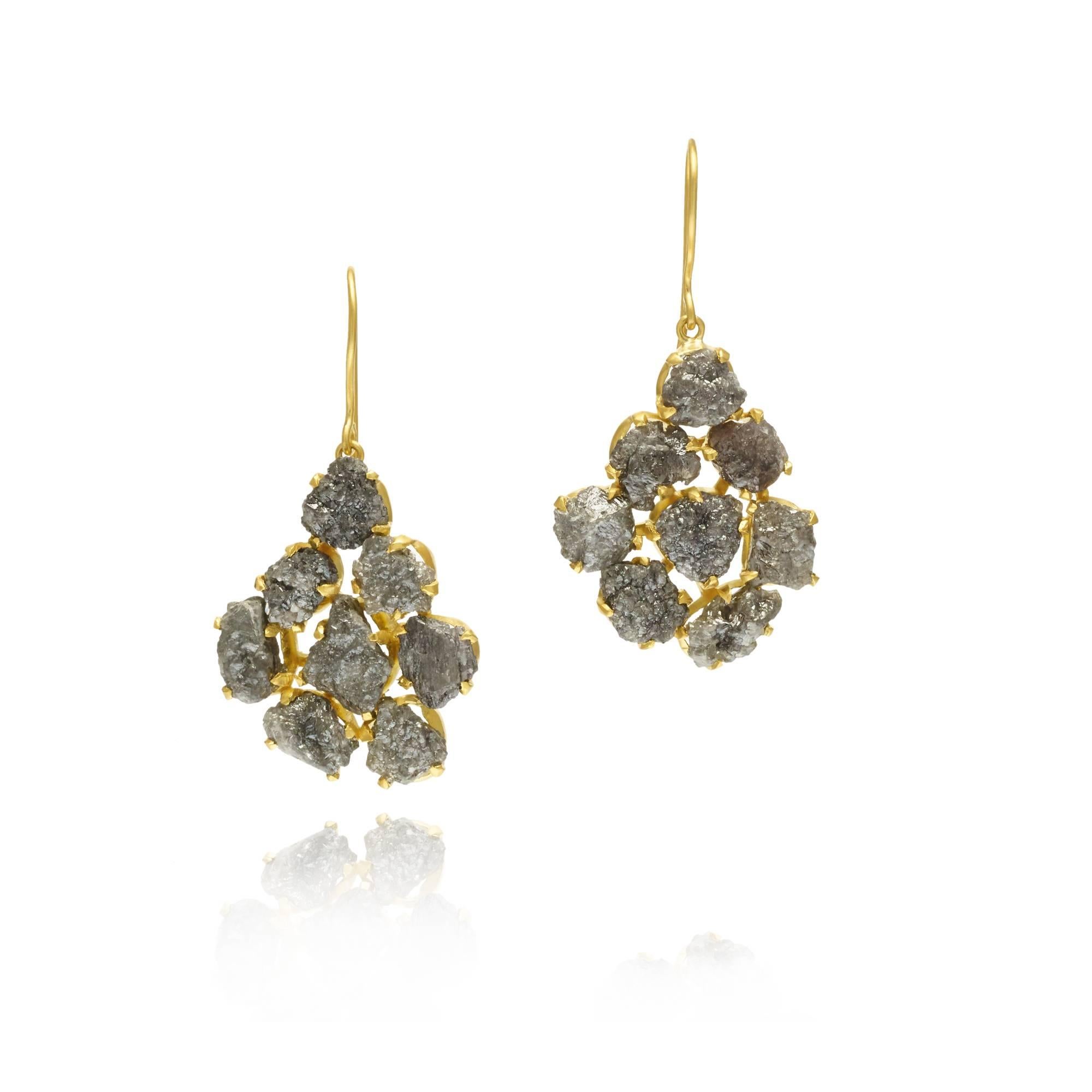 Evoking a quiet glamour of another era, the invisible collection combines the earthiness of uncut stones with the allure of sparkle. Differing from Pippa's traditional colette setting, each Diamond featured in these earrings is held by a delicate