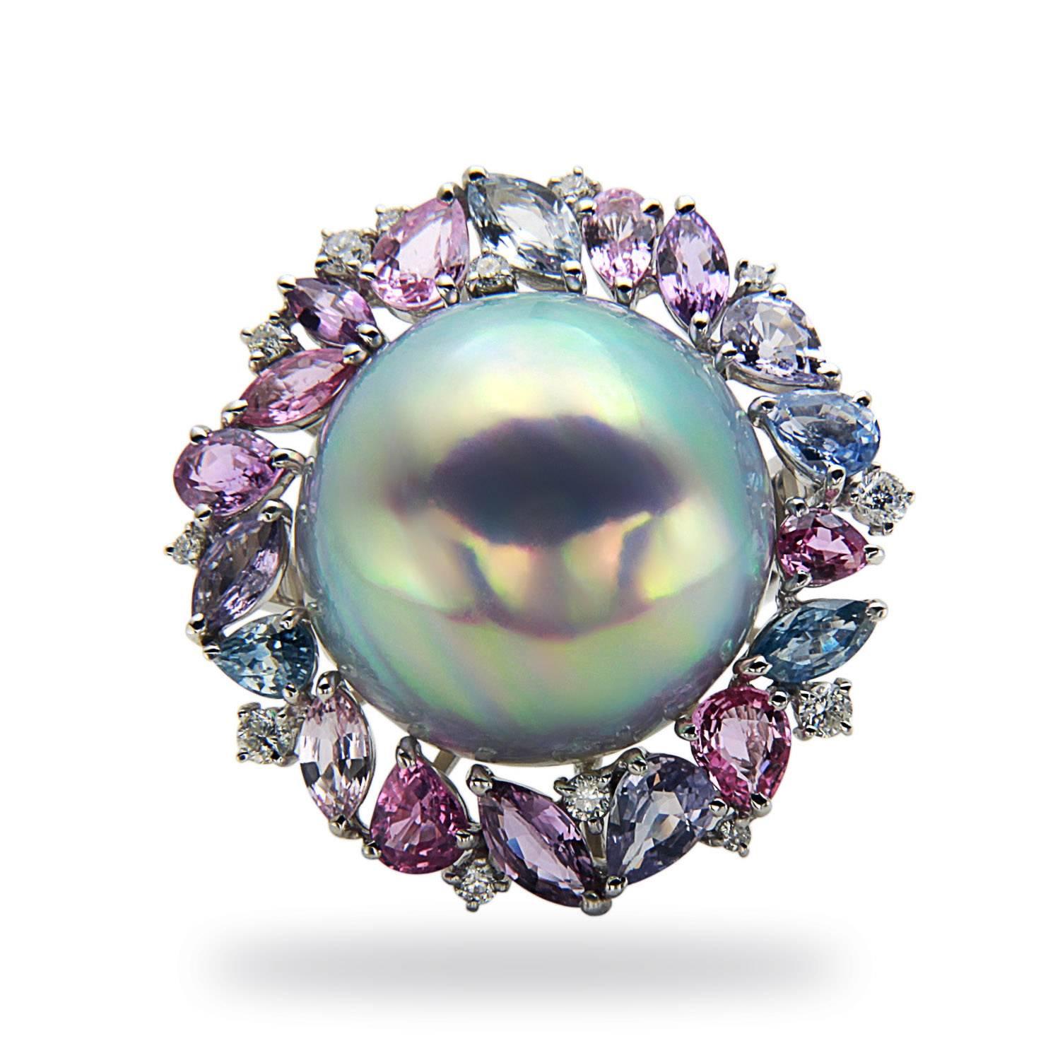 This dramatic cocktail ring is the perfect piece to dress up any outfit. Consiting of a 19x20mm Mabe Pearl surrounded by .35cttw of diamonds and 6.03cttw of multicolored sapphires and it is a great addition to any jewelry box.

Ring Size 7

The