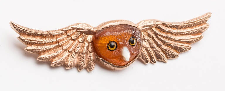 This lovely hand carved brown tourmaline owl's face (by Master Idar-Oberstein carver) with painted crystal eyes & Mother-of-pearl beak is set within 14 karat rose gold hand cast wings. Large pin closure on back.