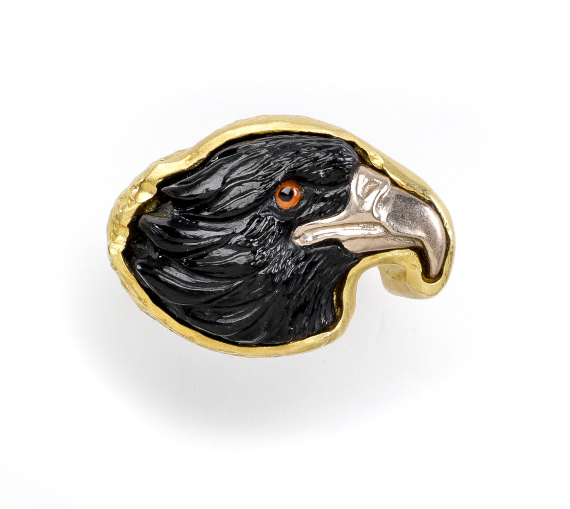 Beautifully detailed hand carved black jade eagle (by Master Idar-Oberstein carver) with a silver beak and hand painted crystal eye. Eagle is right facing and set in a hand crafted 18 karat yellow brushed gold deep shank.  Also available in earrings