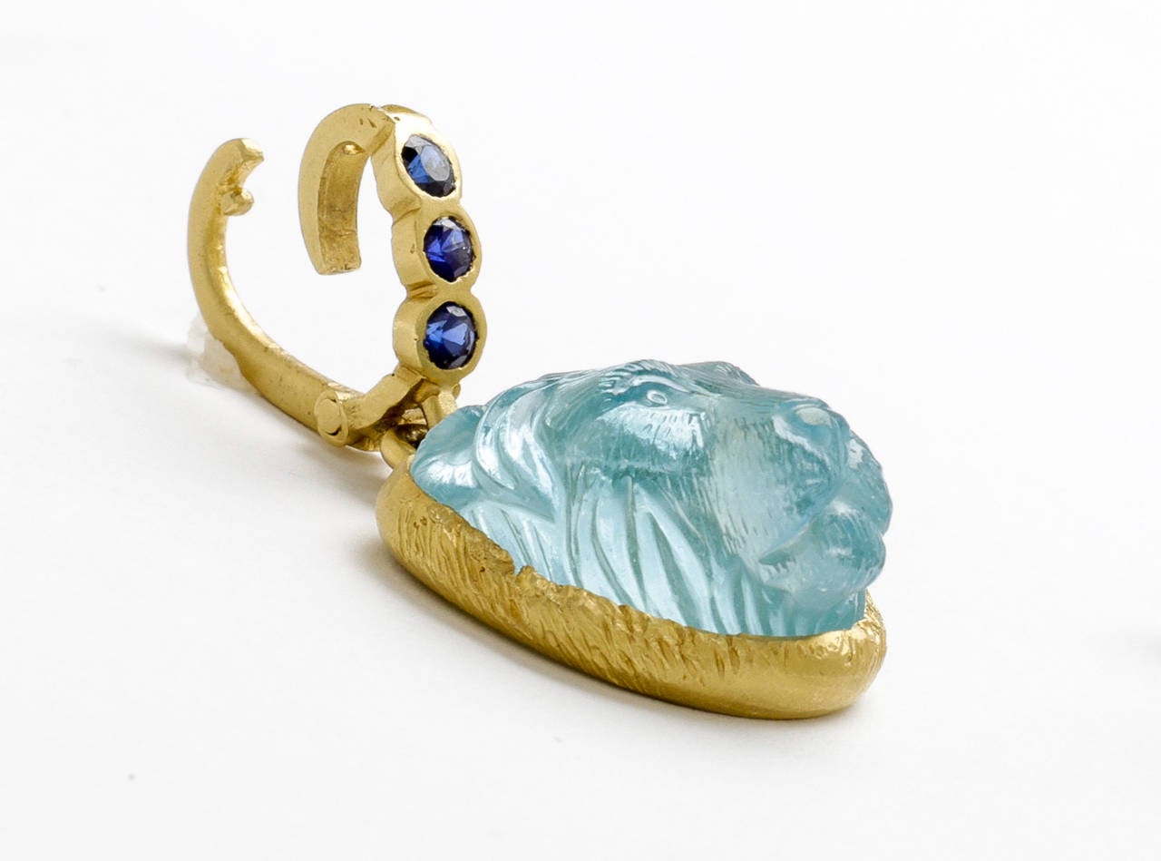 Beautiful bright blue aquamarine hand carved lions head pendant  (by Master Idar-Oberstein carver) with deep blue sapphire bail (.30 carats)in hand crafted 18 karat yellow brushed gold (natural stone sizewith inclusions 18mmx20mmx12mm).