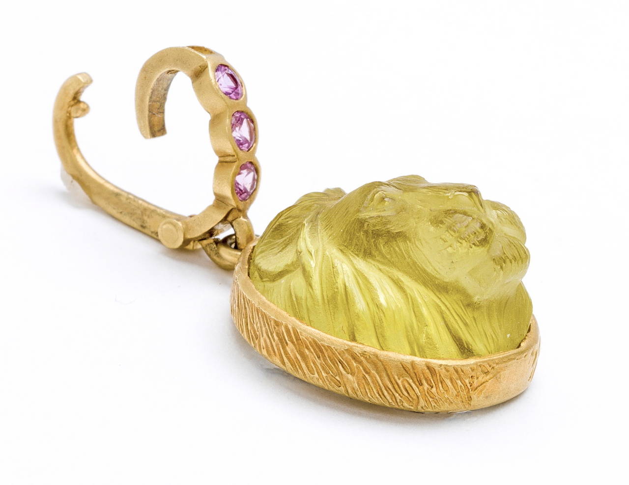 Regal hand carved yellow tourmaline lion's head pendant (by Master Idar-Obenstein Carver) set in handcrafted 18 karat brushed  gold setting with .30 carats pink sapphire bail.(stone size 22mm X 19 mm X 12mm)