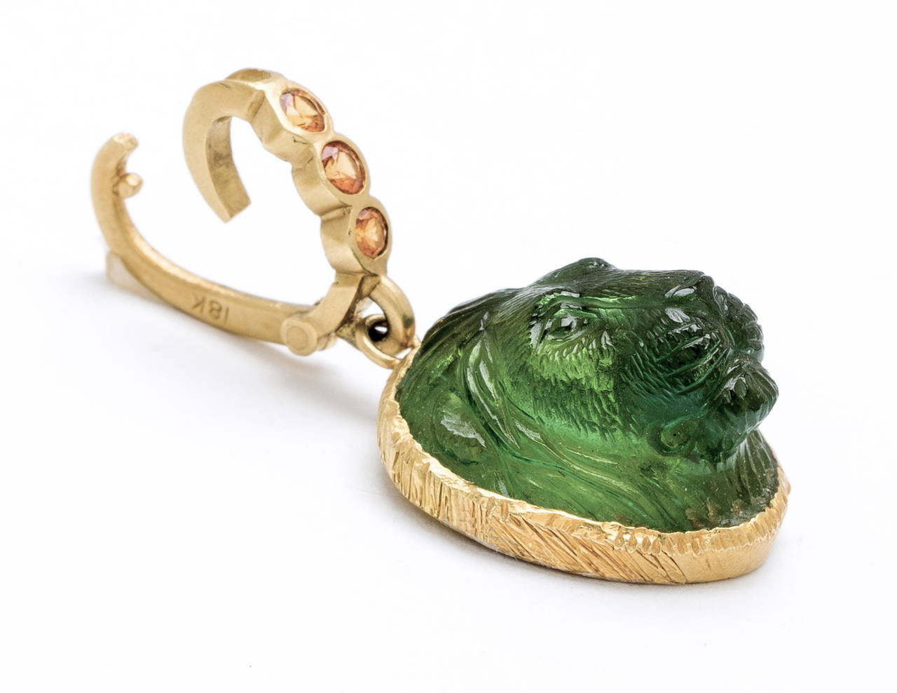 Hand carved Green tourmaline lion's head (by Master Idar-Obenstein Gem Carver) with 18 karat mane setting and detachable .30 carat yellow sapphire bail (19mm X 20mm X 12mm)