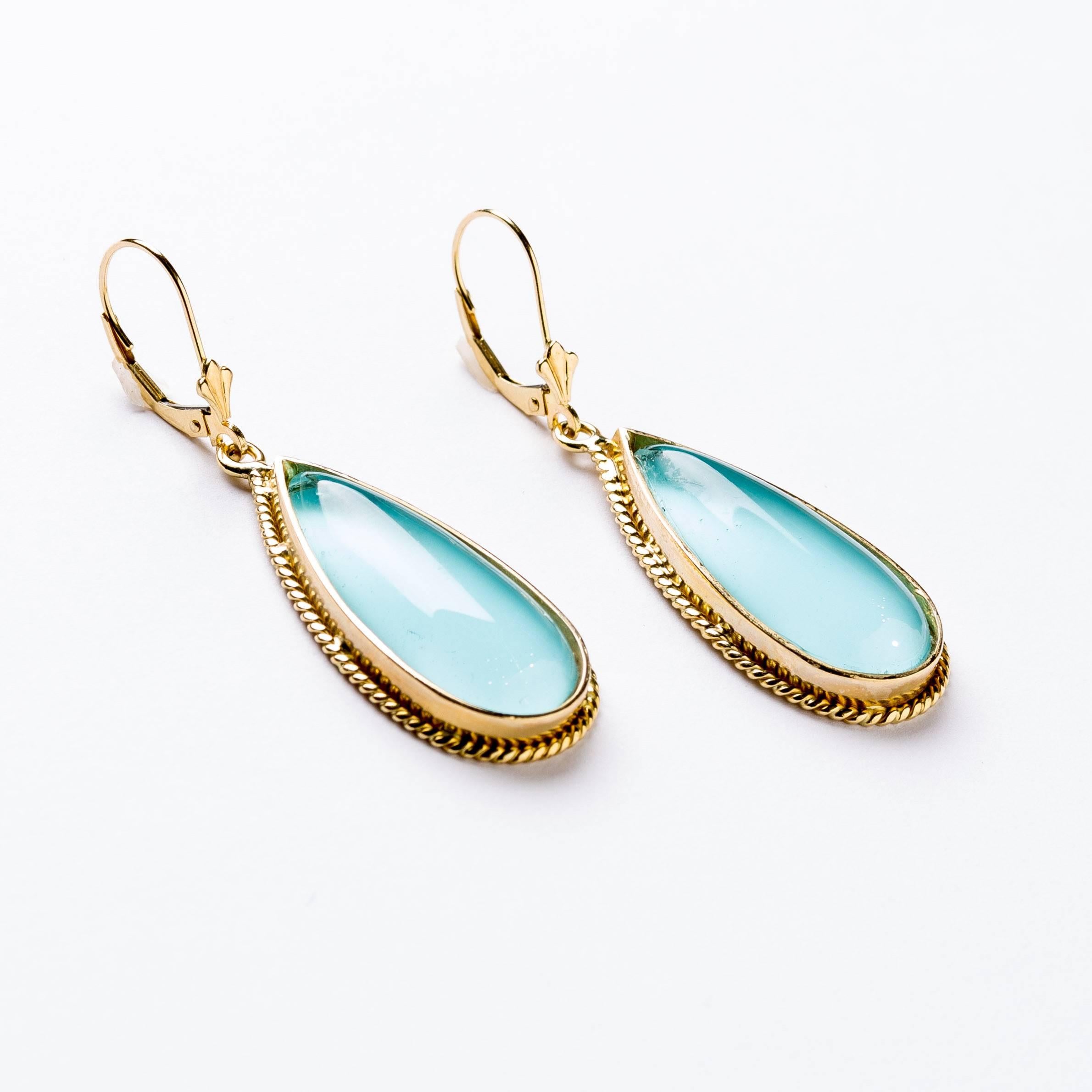 Beautiful doublets of turquoise and quartz crystal framed in 18 karat gold.