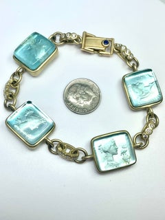18k bracelet with diamond links and blue MOP goddess profiles in carved reverse