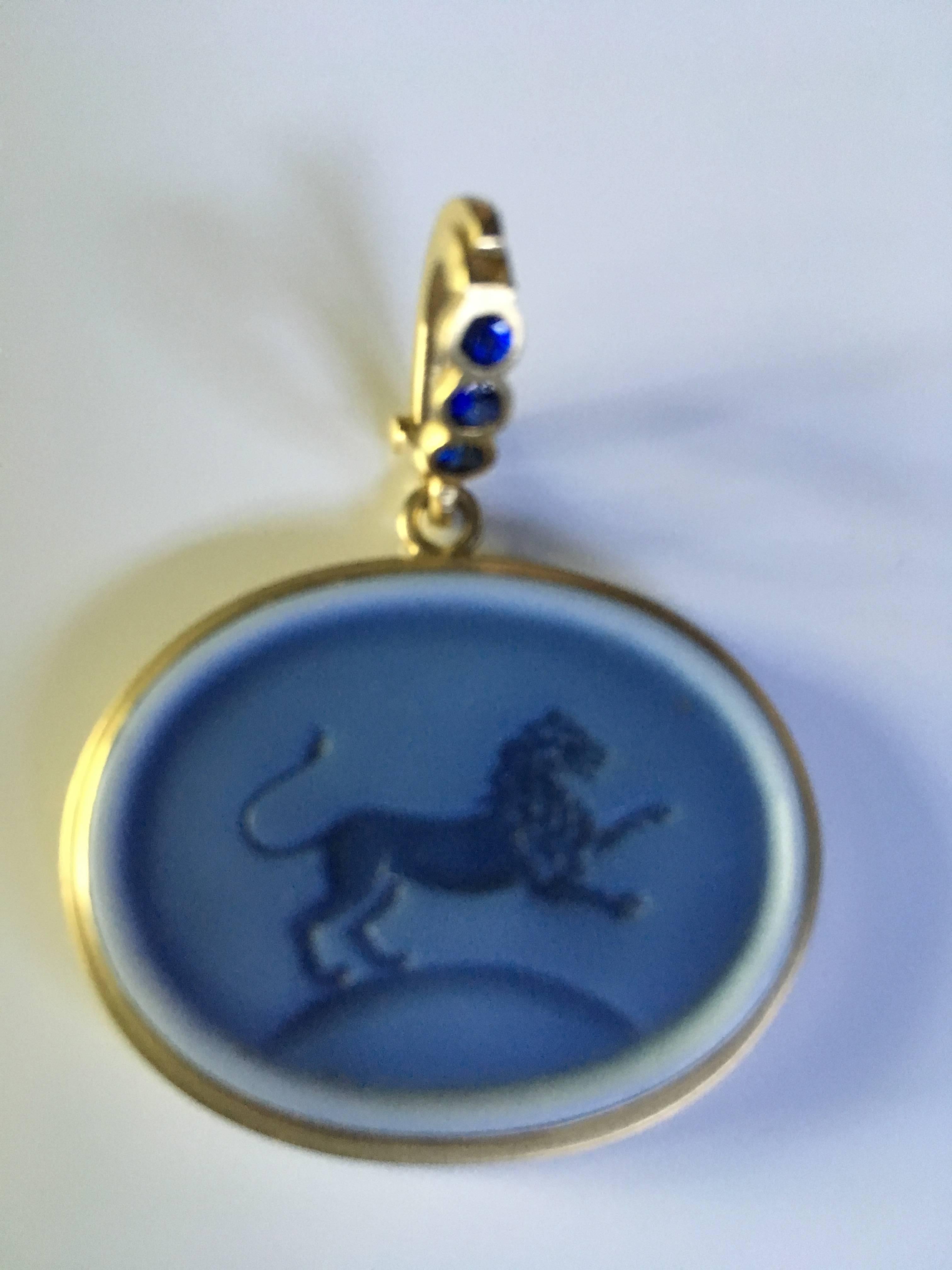 Beautiful 18K carved spectra lion pendant with blue sapphire bail measures 18x24mm