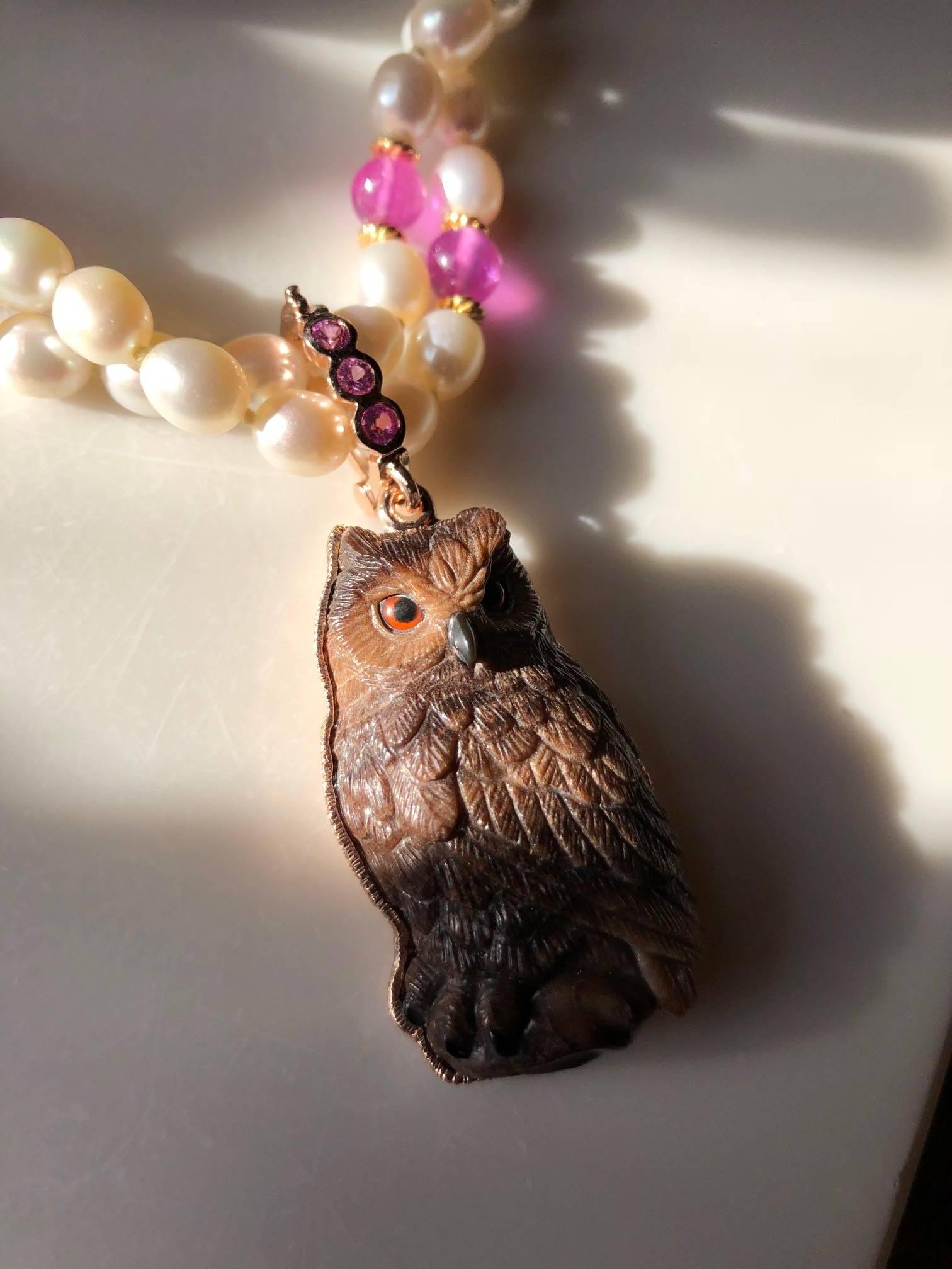 Exquisitely carved owl pendant with 18 karat gold pink sapphire bail  and pearl with pink sapphire beaded matching necklace .									
The necklace is 32 inches long and the owl is 1 3/4 inches long 1 inch wide with .30 carats pink sapphire