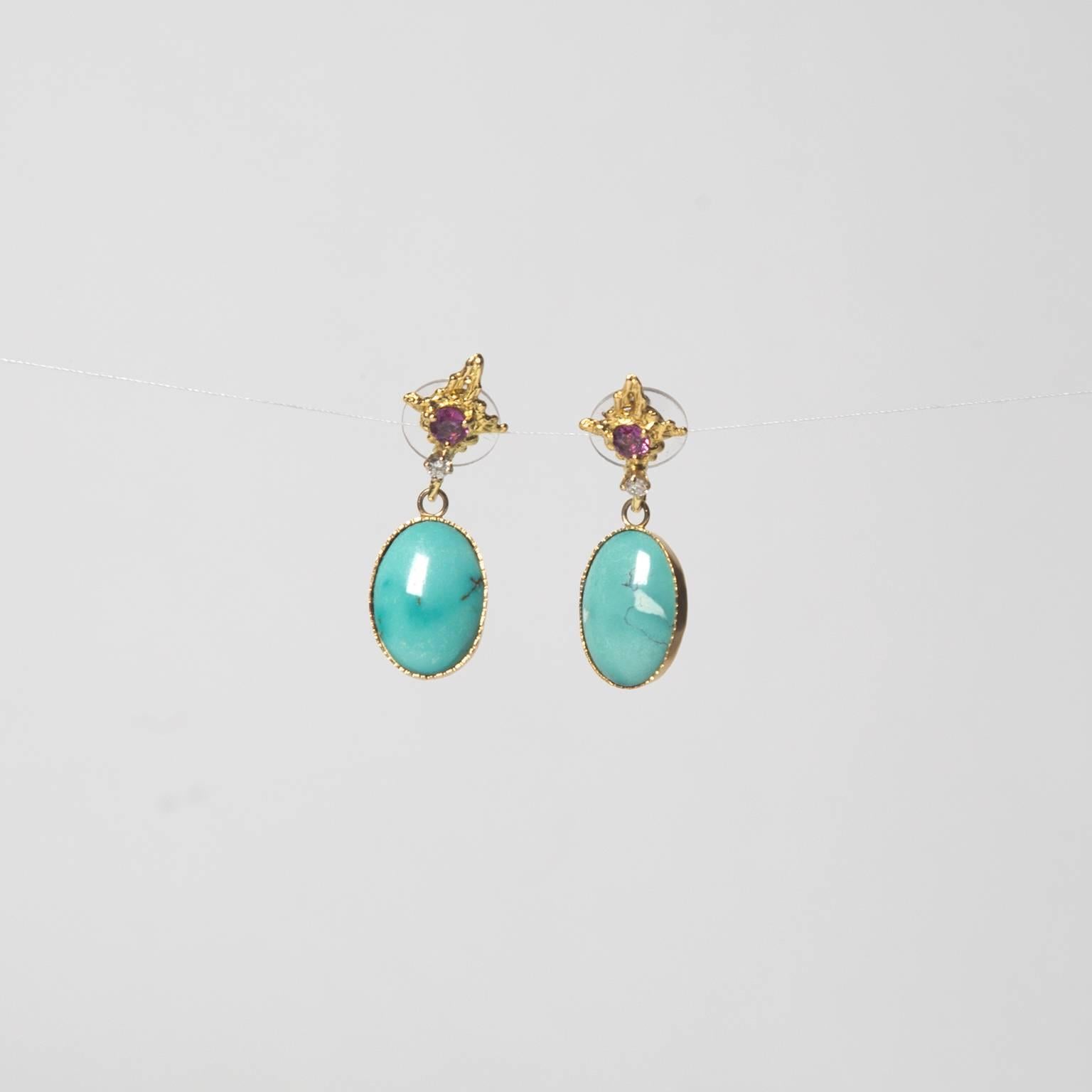 Persian turquoise set in 18K gold, suspended by a perfectly cut ruby and diamond stone. 