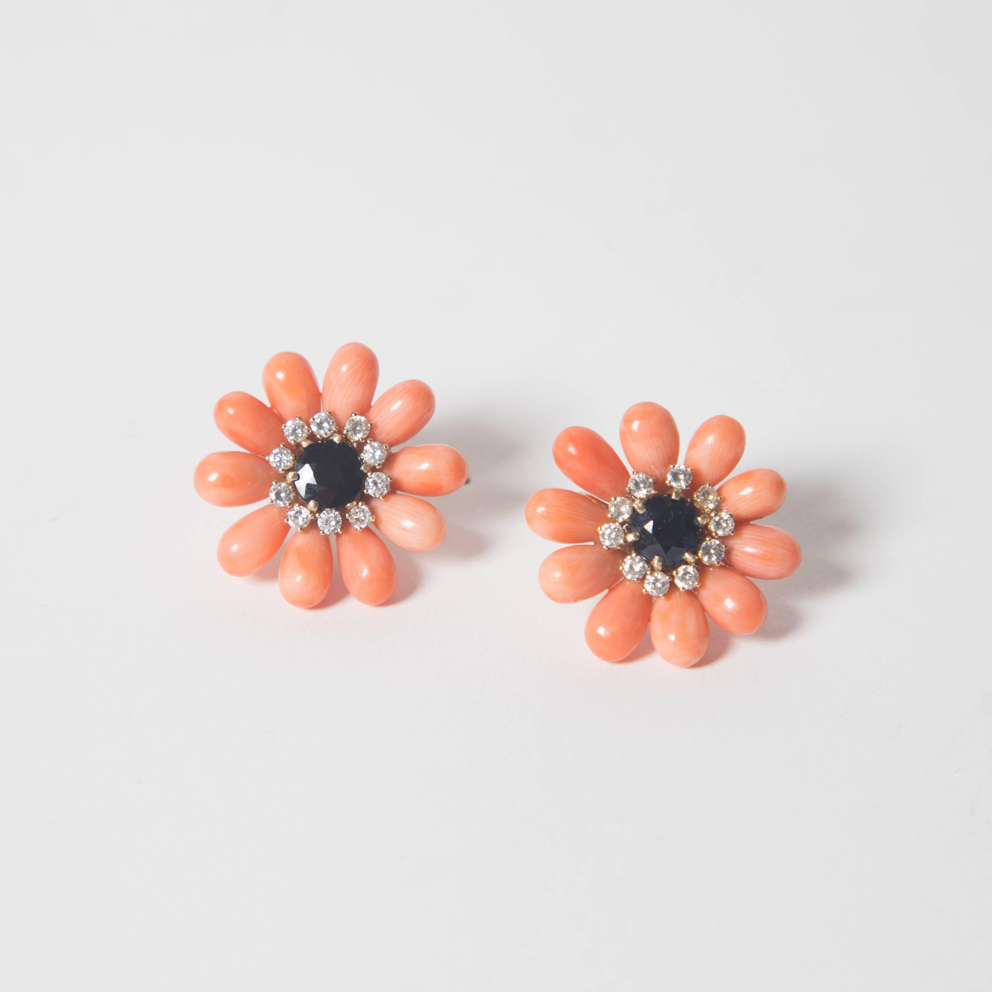 Sapphire and diamond stones centered around stunning precious coral petals. 