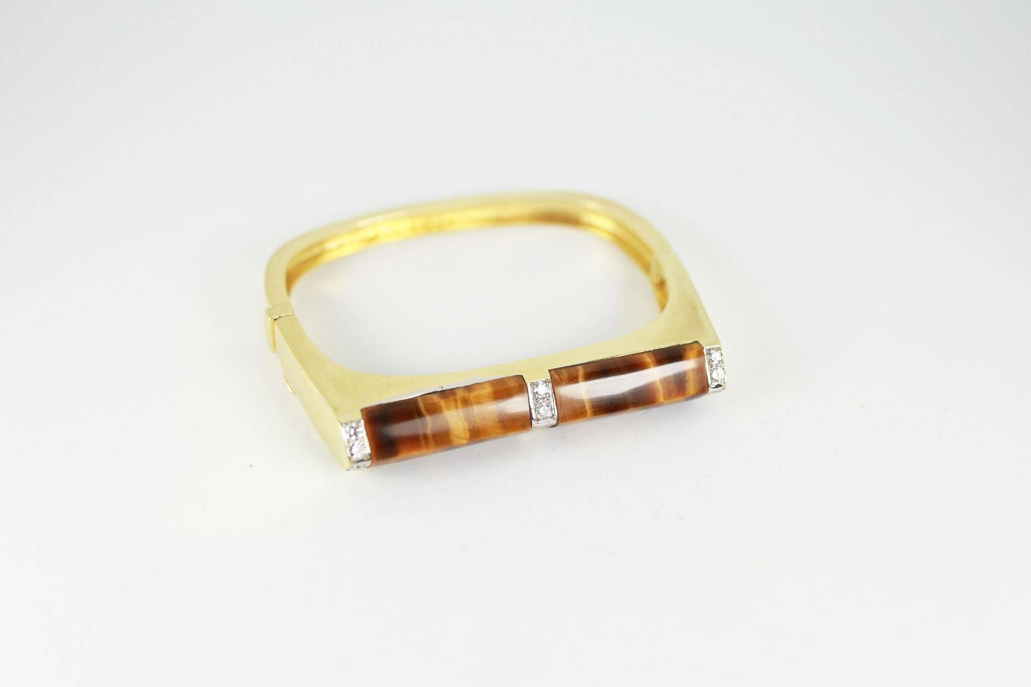 Solid 18K gold cuff inlaid with beautiful tiger's eye and framed with diamonds. Fits a small wrist.