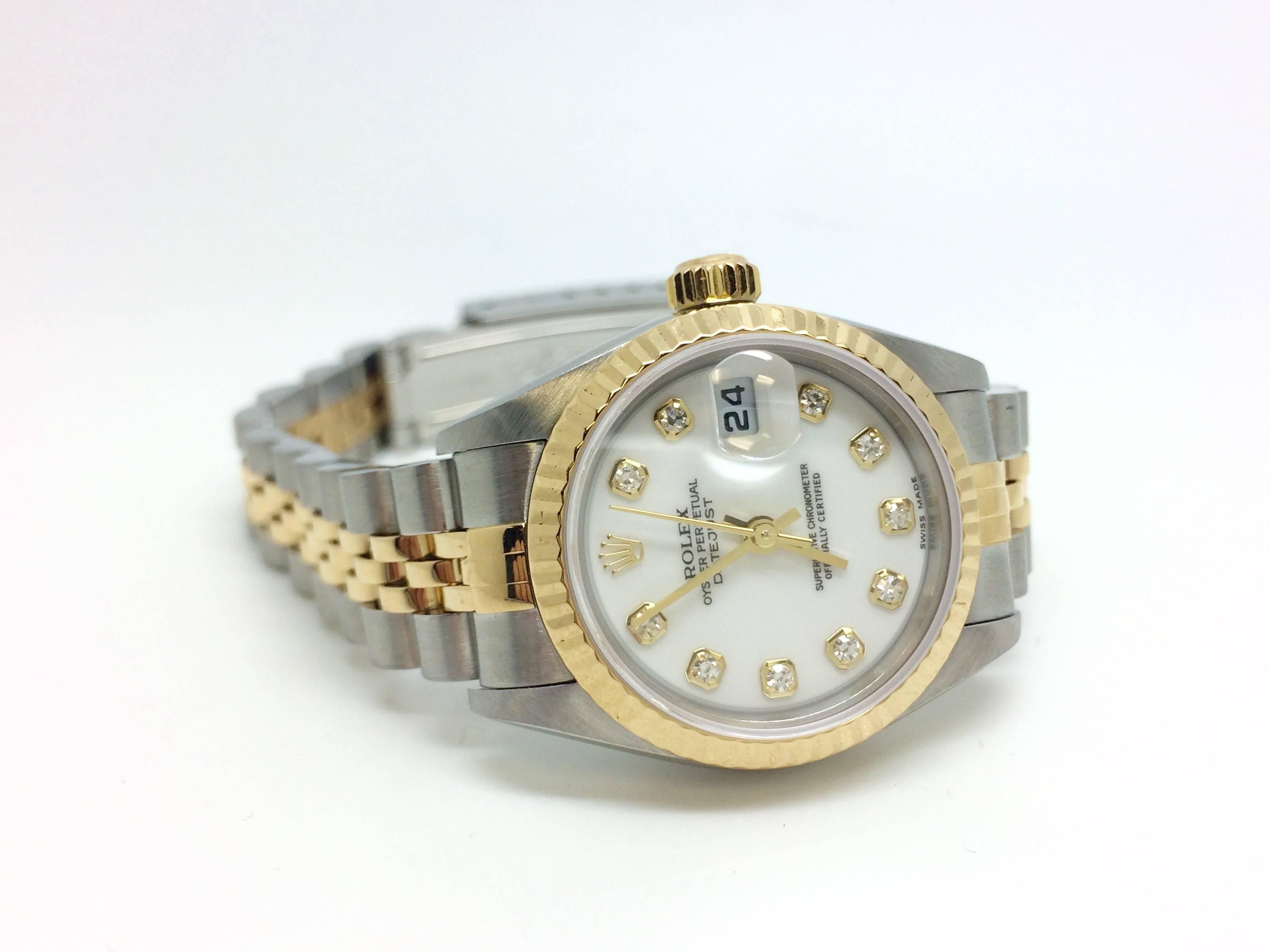 Rolex Lady's two tone Datejust Ref # 79173 pre-owned 26mm timepiece.  The dial is white with diamond markers and a classic fluted bezel.  The case is steel with 18 kt yellow gold and steel jubilee bracelet, inside wrist measurement approximately 7.5