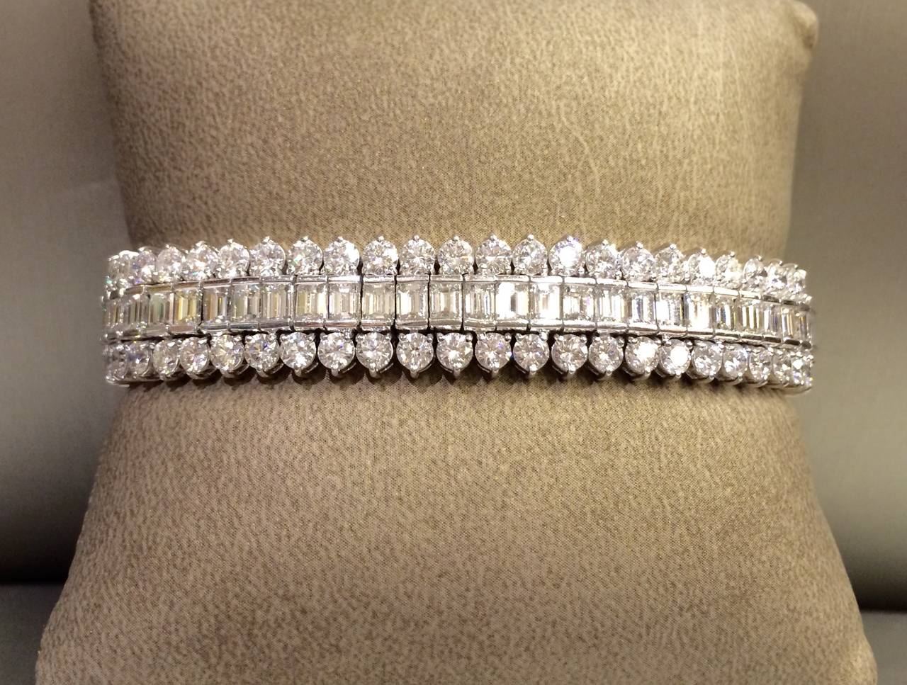 Fancy link diamond bracelet in platinum with round brilliant cut diamonds and emerald cut diamonds. Carat total weight approximately 29.00.