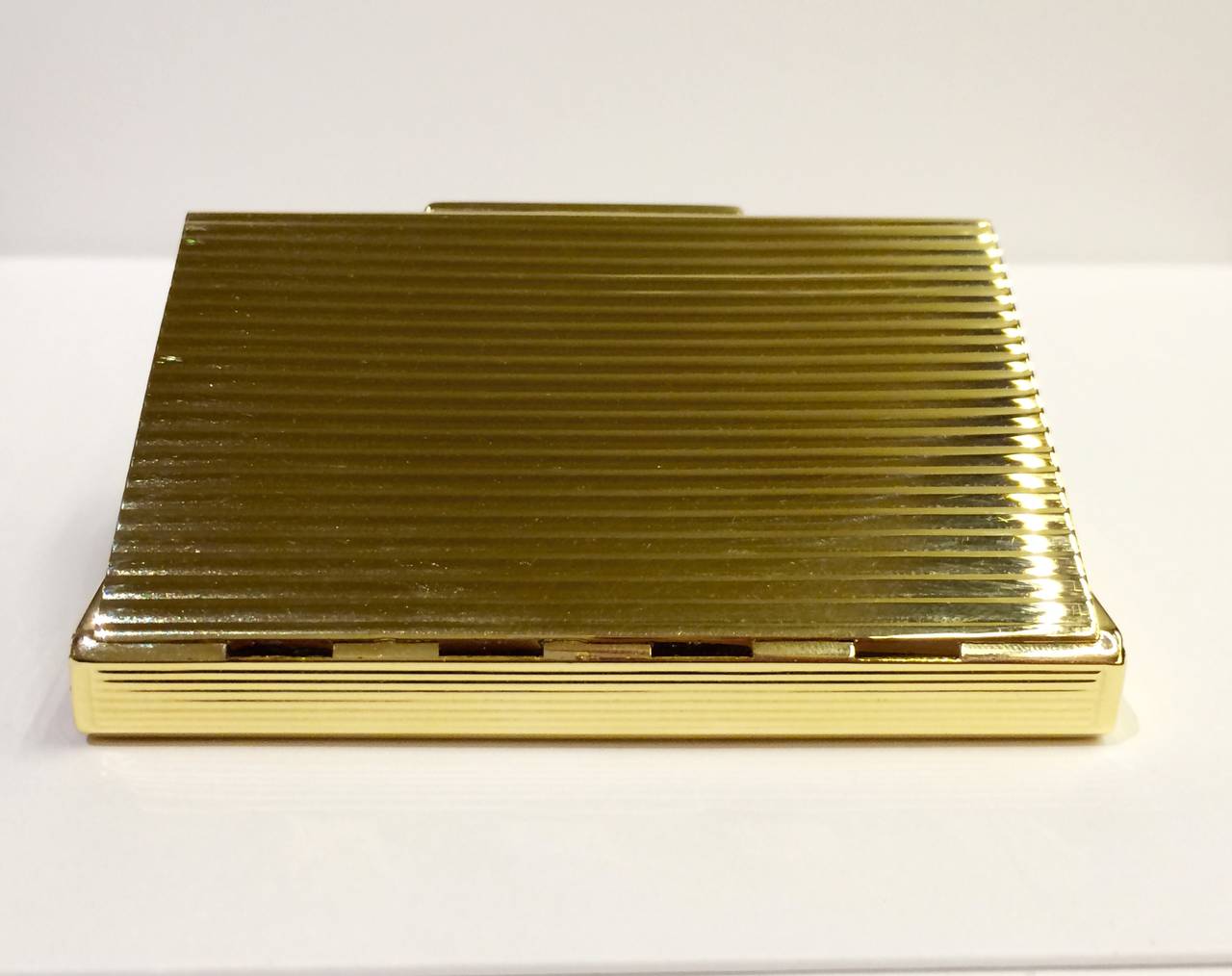 18kt yellow gold rectangular cigarette case, hinge closing, classic style with grooved edges, high polish finish on outside and beautiful matte finish on inside.