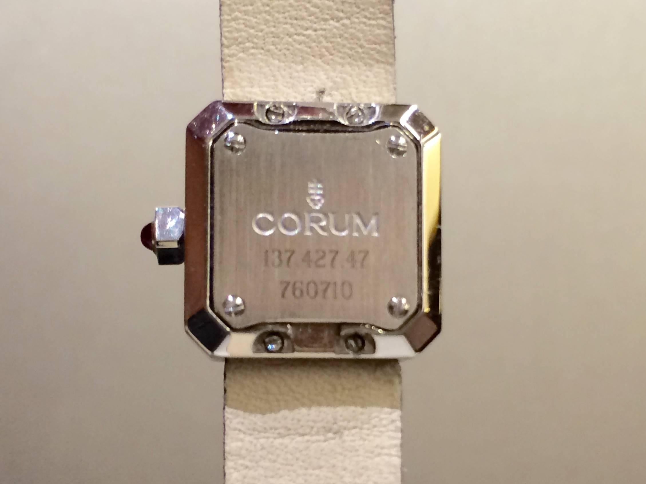 This petite ladies watch from Corum's Sugar Cube collection has just the right amount of sparkle to really make this piece stand out. The watch is made of stainless steel and has a bezel entirely set with diamonds. Features a pink dial which