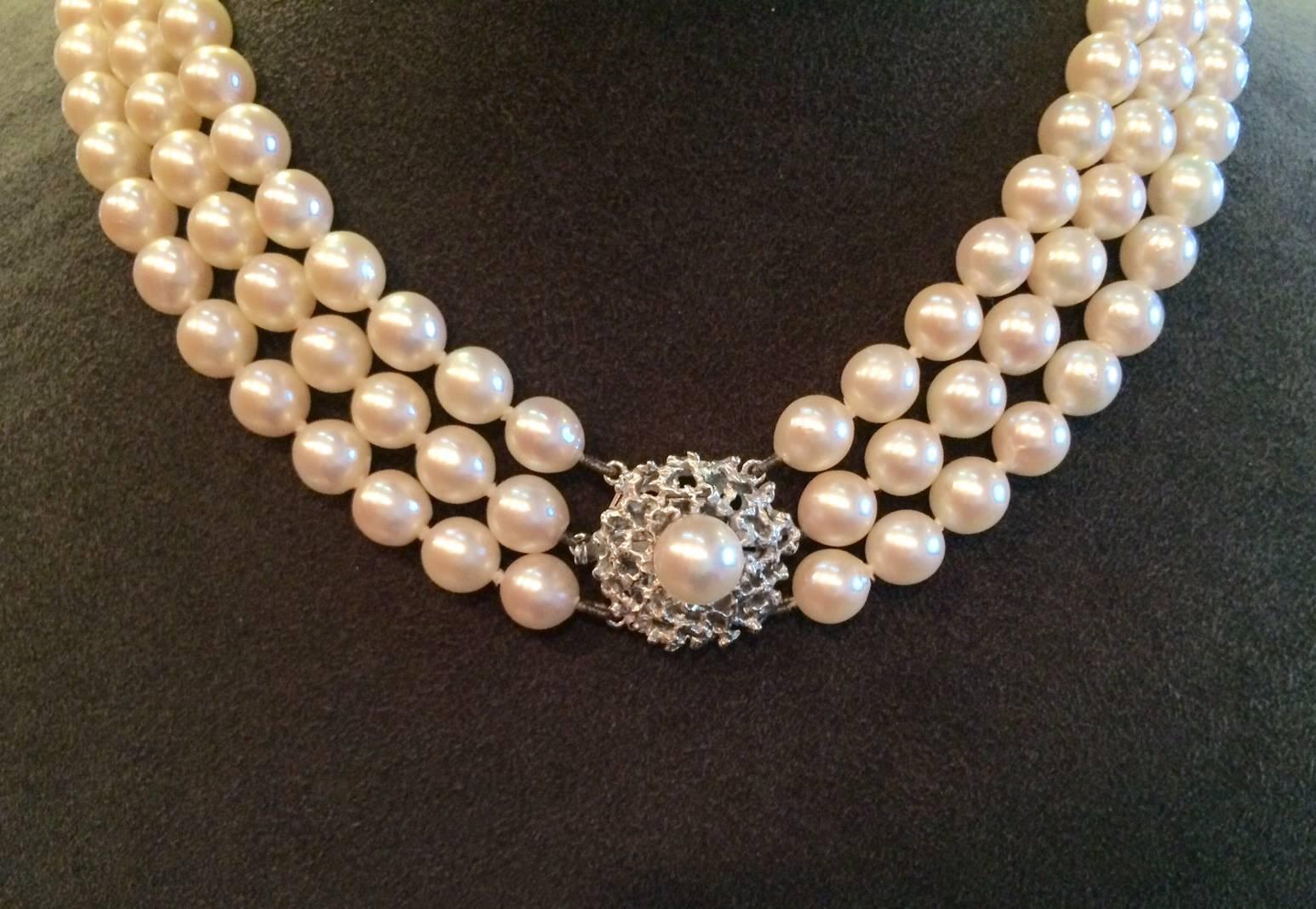Triple strand pearl necklace with fancy designed 18kt white gold clasp and safety clasp. White pearls are 6.5-7mm in size making this a beautiful necklace that can be worn day or night.  Clasp is a unique feature that can be worn either on front or