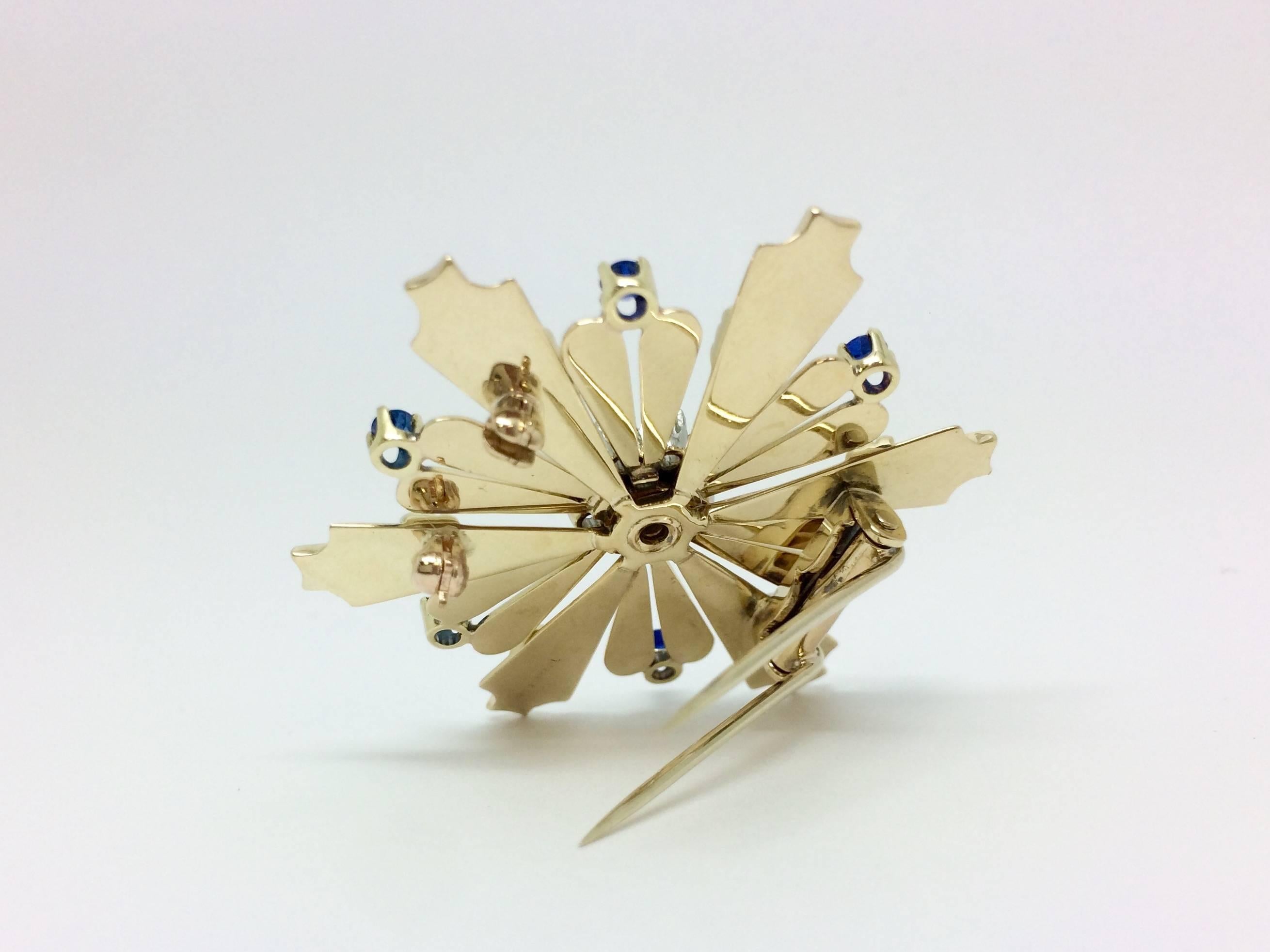 Brooch stamped Tiffany & Co., set with diamonds & blue sapphire. It is a pre-owned 14kt yellow gold piece that measures 1 3/4 