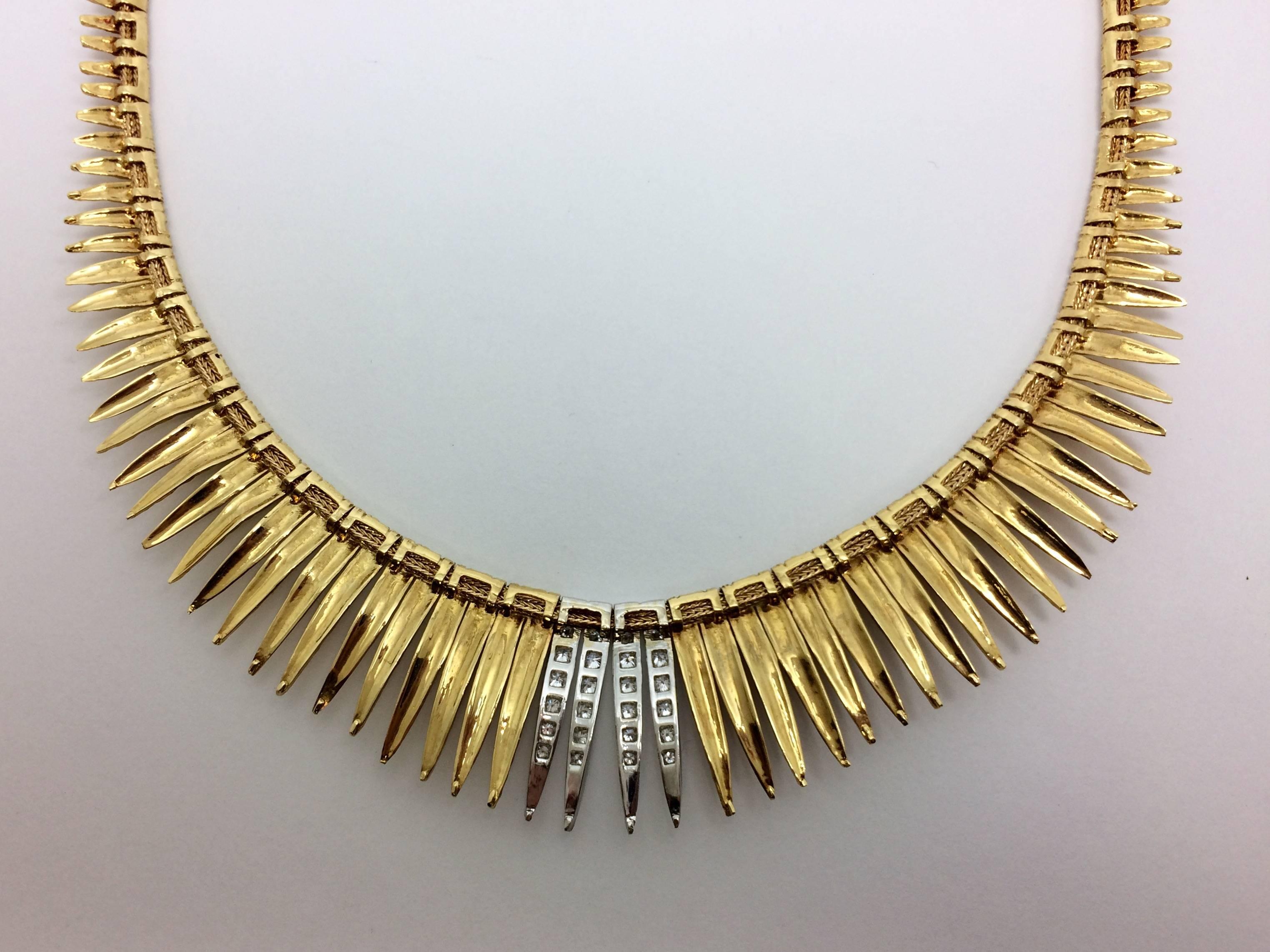 One 18kt yellow gold and diamond collar style style necklace.  This pre-owned piece certainly makes a statement.  It is graduated as it goes down and lays flat on the upper décolletage. Diamonds adorn the center four links. Measuring approximately