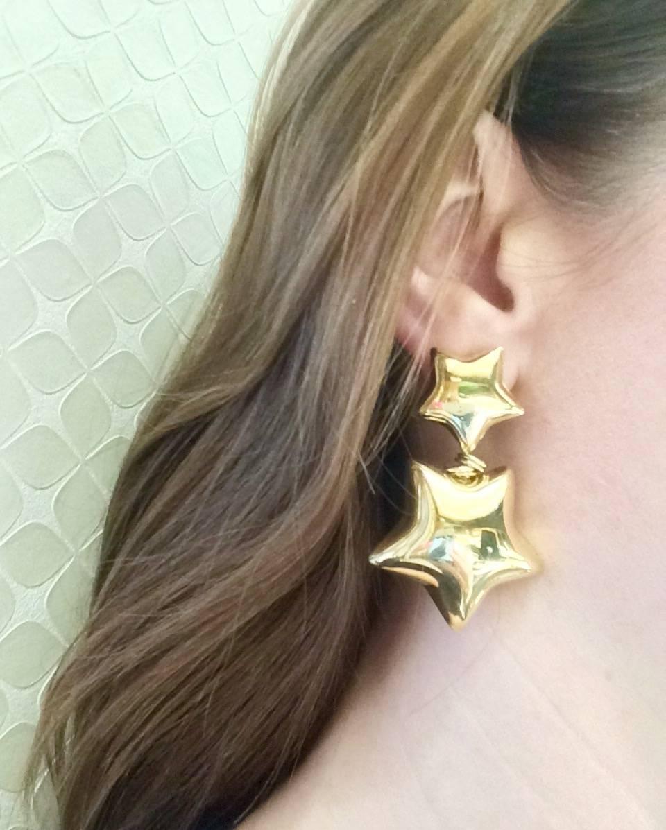 These 18kt yellow gold double star drop earrings that are sure to impress.  What a fun statement pair of earrings to wear and enjoy.  Made for pierced ears with an omega European style clip to hold them securely in place. They weigh approximately 22