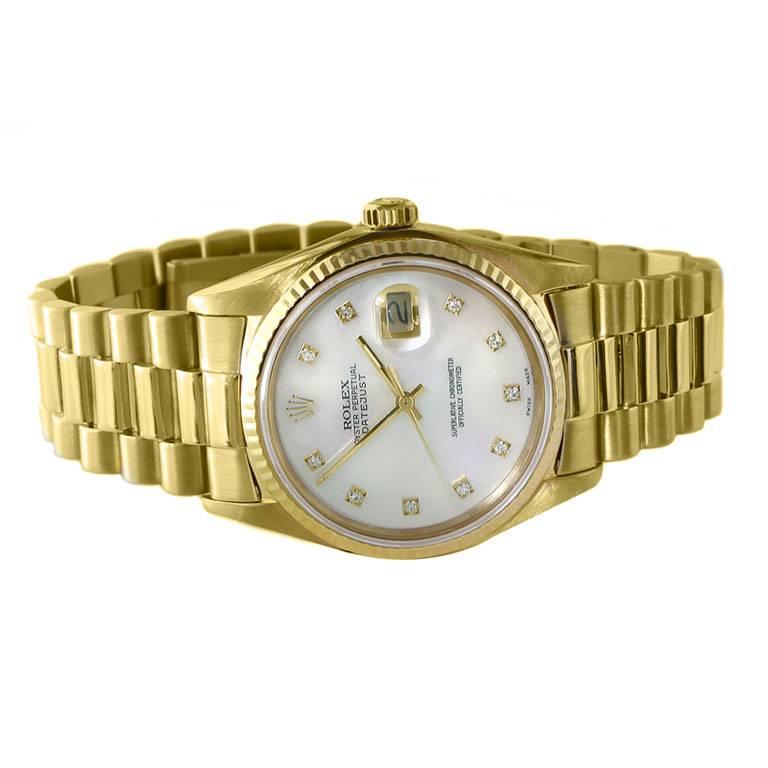 A terrific looking 35mm unisex pre-owned 18kt yellow gold Oyster Perpetual Datejust Rolex ref 16018.  With date, white mother-of-pearl dial and round brilliant diamond dial markers. Featuring a 36mm case with sapphire crystal, this special timepiece