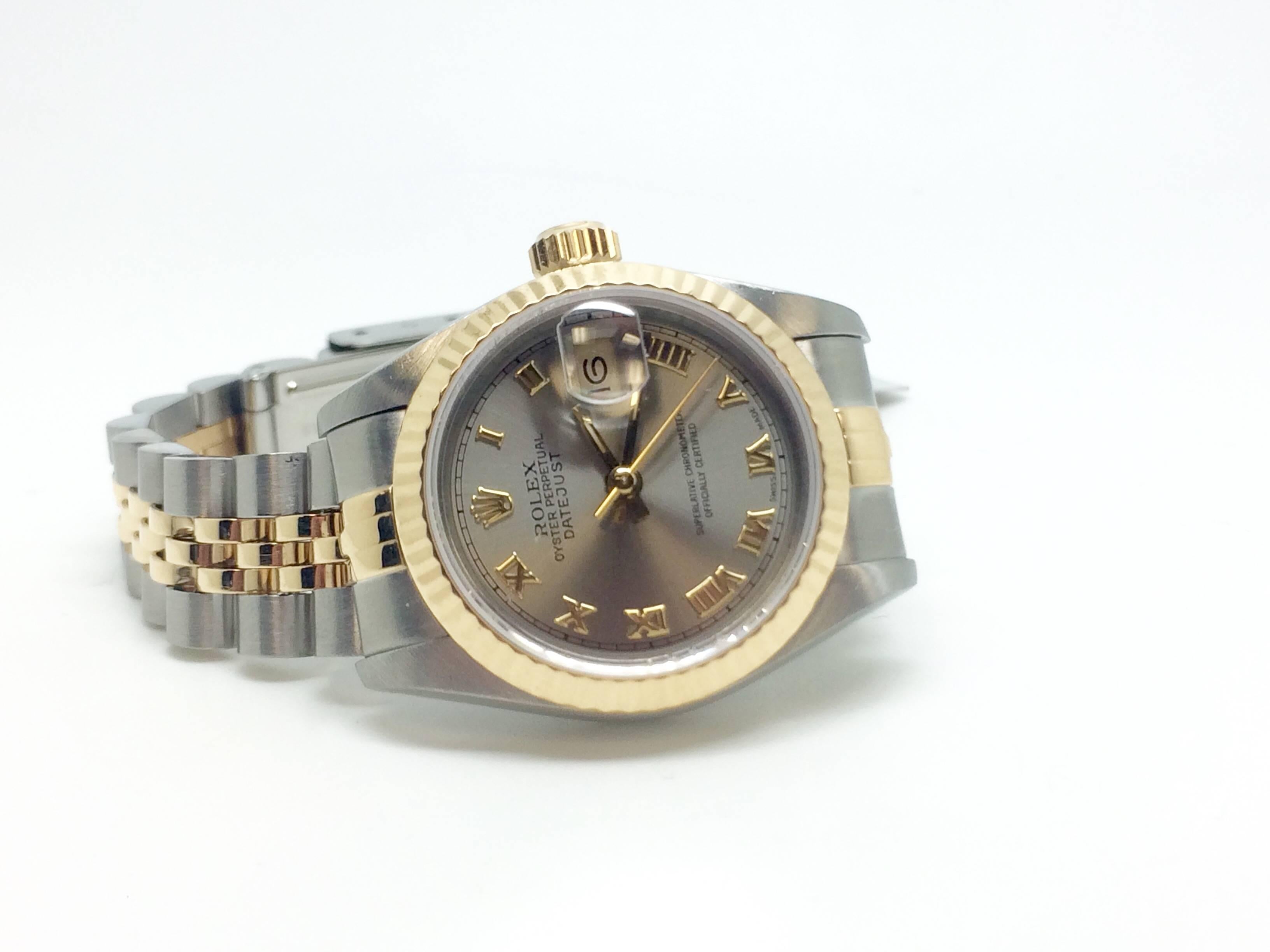 Rolex lady's estate wristwatch. This is a 26mm, circa 1991, Ref. 69173.  Two tone stainless steel and 18kt yellow gold jubilee bracelet with 18 links. Approximately 6.5 inches inside wrist measurement. The dial colour is steel with yellow gold roman