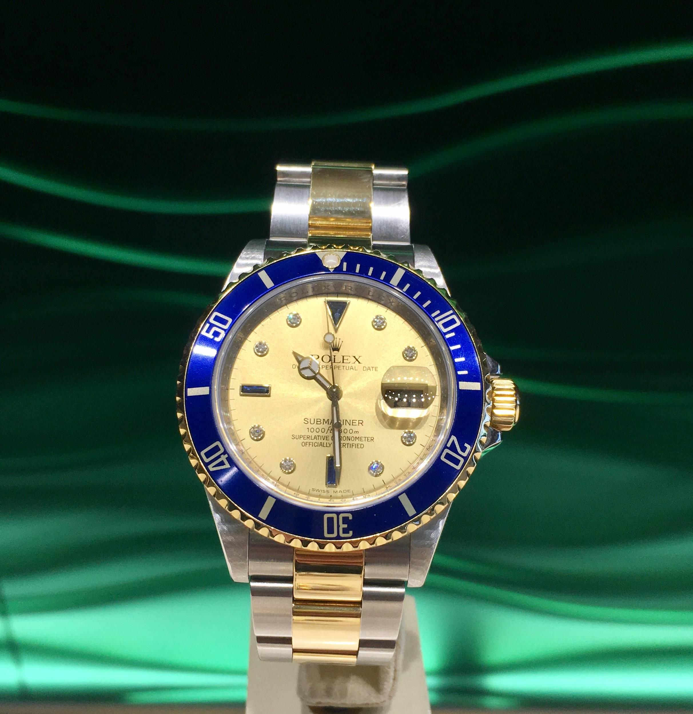 Pre-owned Rolex O. P Submariner Date with yellow gold and stainless steel, 40 mm case, blue insert, 20mm rolesor oyster fliplock bracelet, champagne dial with 8 round brilliants, three sapphires model # 16613  serial # M9591_ _, comes with box.

