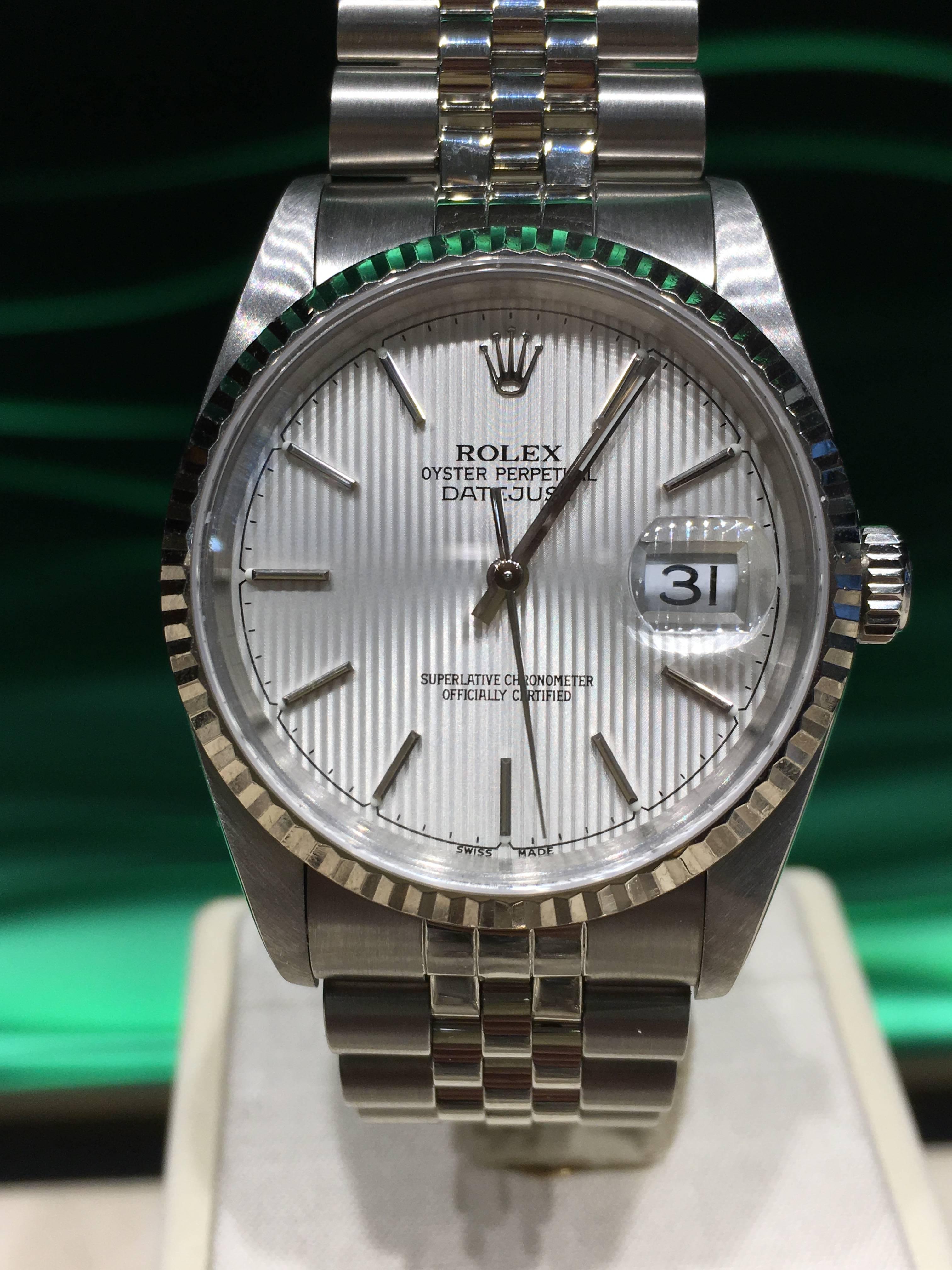 Rolex Oyster Perpetual Date just automatic winding timepiece, 31 jewels, quick set with sapphire crystal. Stainless steel case 36mm diameter. fluted bezel, stainless steel jubilee bracelet, silvered tapestry dial with stick markers. Model # 16234,