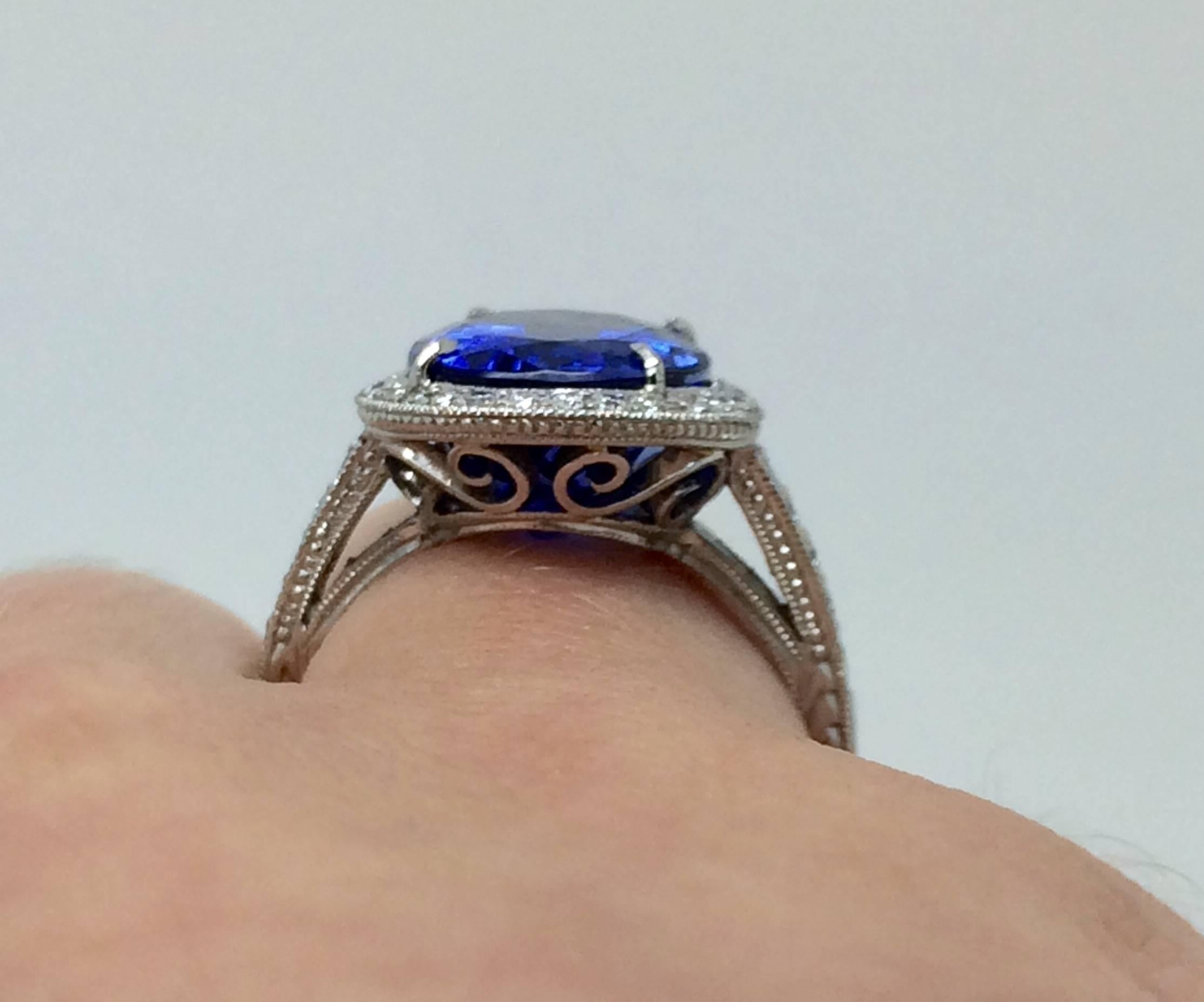 This ring is fit for royalty!  Set in platinum and holding a fancy oval tanzanite weighing 7.28CT.  With a medium dark tone, moderately strong intensity, violetish blue colour, medium make it is a striking combination. Round brilliant cut diamonds