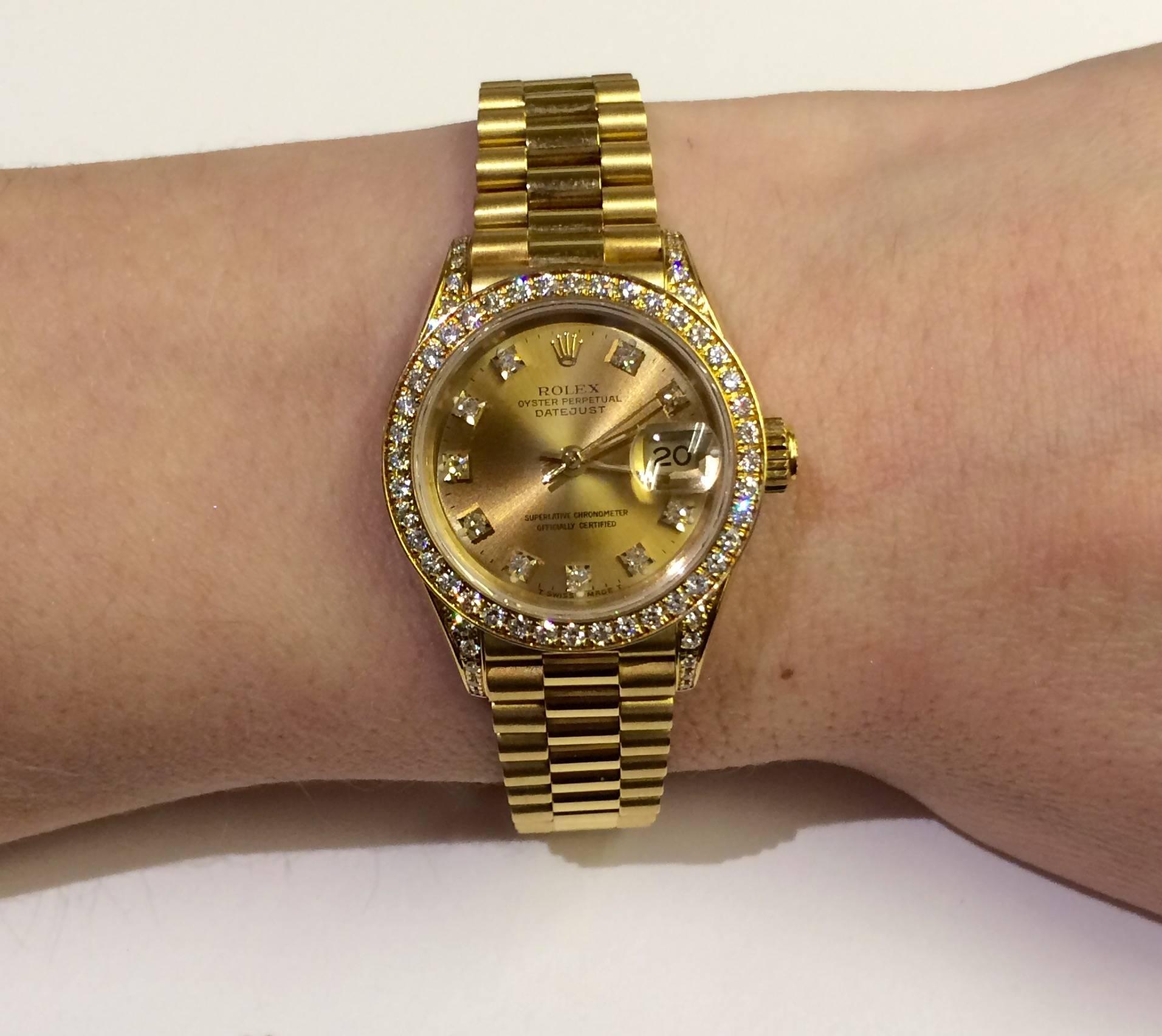 Lady's 18kt Yellow Gold Pre-Owned Rolex President w/ hidden-clasp watch.
24 diamonds on bezel, Automatic movement with date, Quickset date, scratch-resistant sapphire crystal, waterproof screw-down crown. Pre-owned. Model #69158,  Serial #  X577857