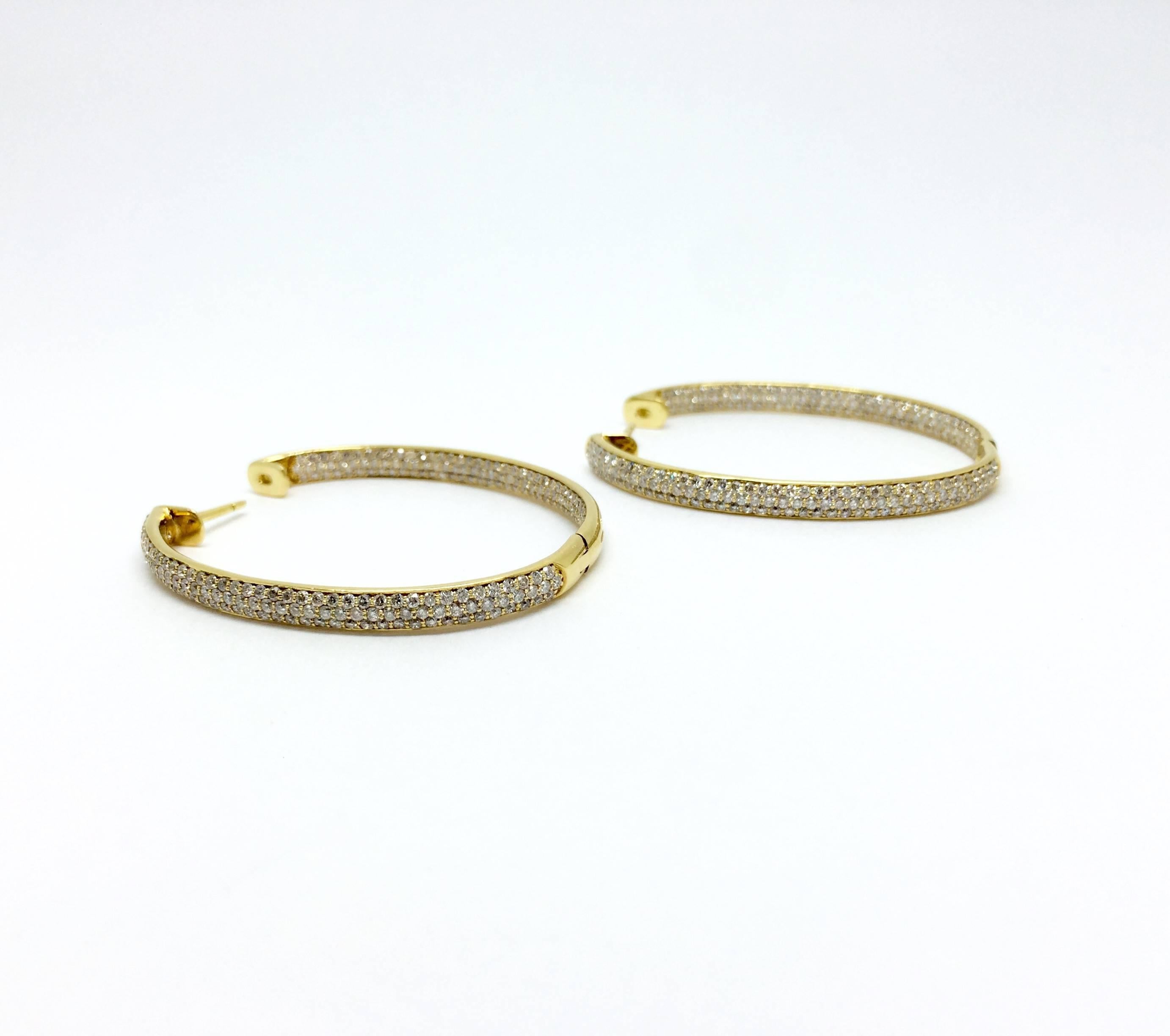 Hoop style earrings in 18k yellow gold with pave set round brilliant cut diamonds. Carat total weight approximately 2.24.