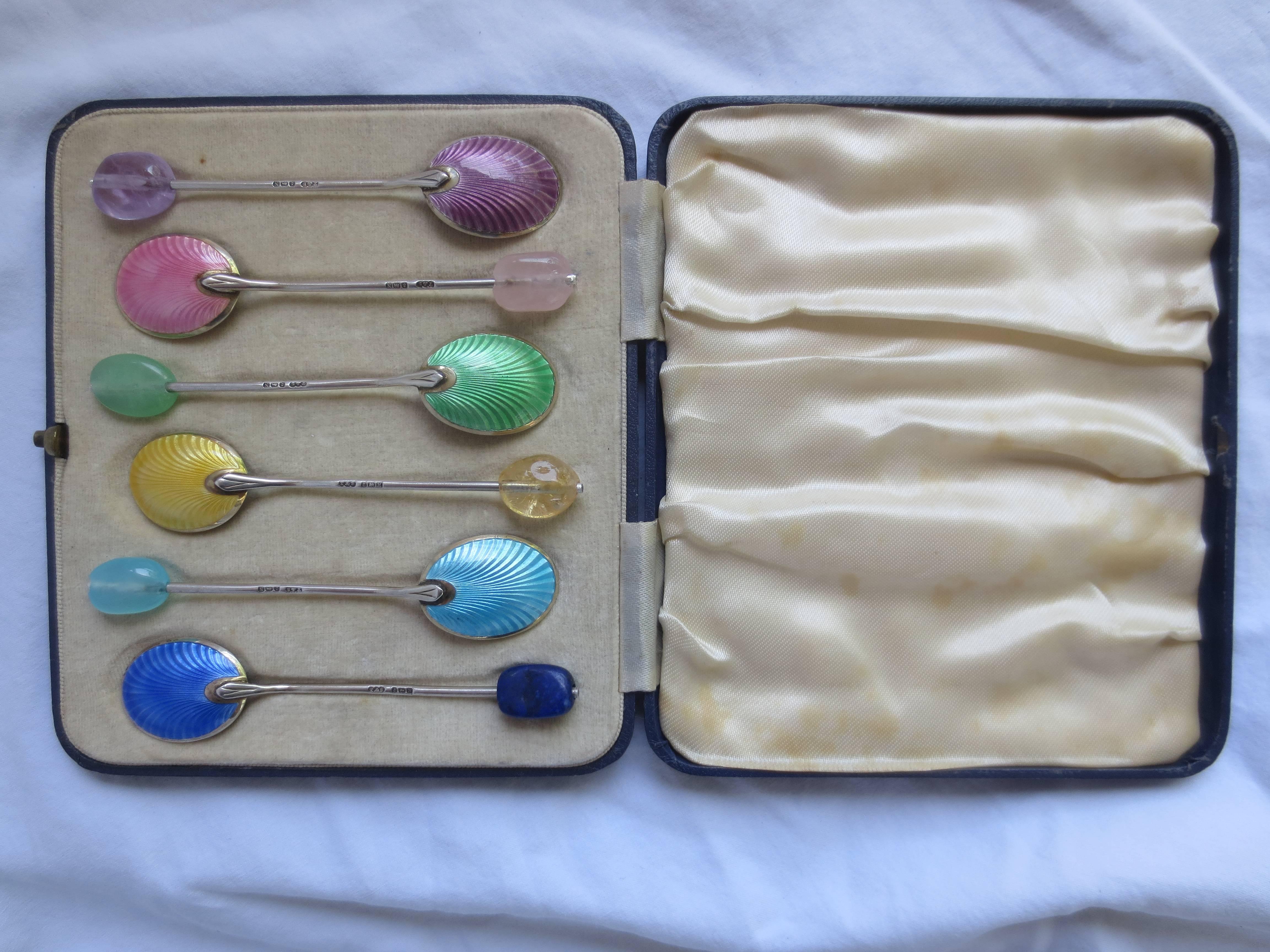 Vintage sterling silver-spoon set in original box. Stamped Turner and Simpson (T&S). The spoons have been refitted with semi-precious stones to match the beautiful enameling on the spoon underside. The stones are Green Topaz, Amethyst, Citrine, Blue