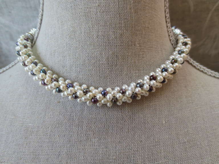 White pearl and black pearl are woven together to create a rope style necklace. Beads measure 3.5mm each, and woven into a thick tubular rope of approximately 1/3 of an inch. This unique, modern and one of a kind necklace can be worn day or night.