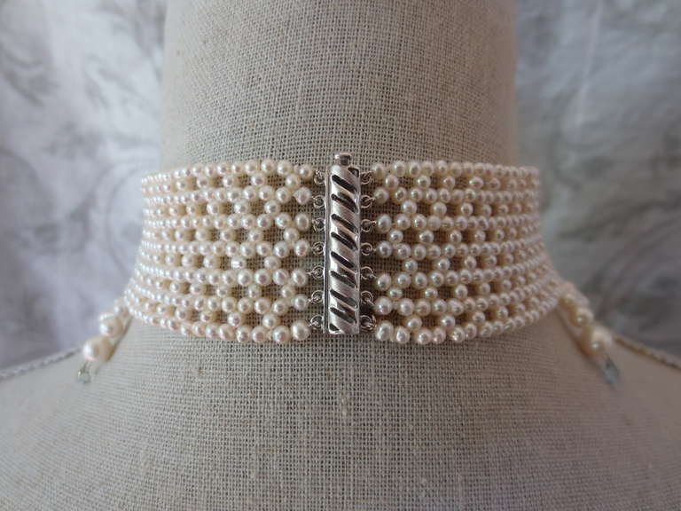 2.5 - 3mm cultured pearls are intricately hand woven to create a delicate lacelike design. Choker measures 13