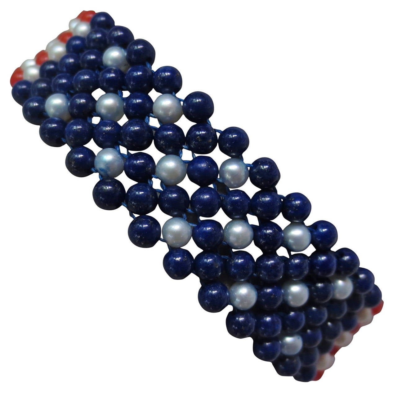 Show your pride for Old Glory.

This unique bracelet designed by Marina J is the perfect piece to wear intime for the upcoming election. 2.5-3 mm beads of culture pearl, coral, and lapis lazuli are intricately woven to create this marvelous Stars