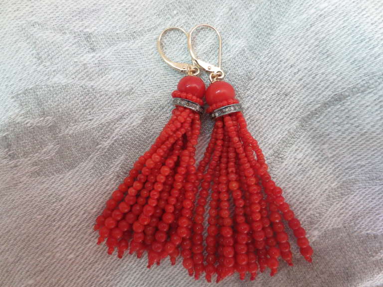 These red coral tassel earrings are made of tiny coral beads measuring approximately 1 mm - 3 mm each. Beads are carefully selected as each strand is graduated in size to create and elegant bell like shape. The tassel strands hang from a larger 6 mm