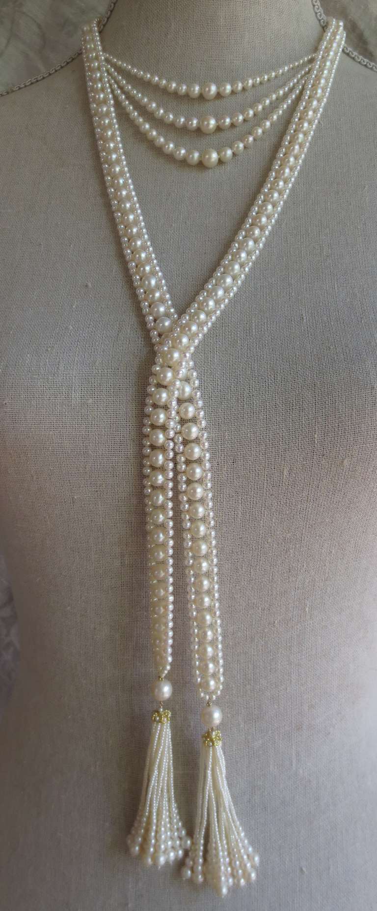 Unique, intricately woven handmade rope sautoir made of 6.5mm and 2.5mm white cultured pearls. Tassels are made of pearl, 14k gold rondelle and graduated pearls. Each tassel is composed of 12 strands of pearls. Sautoir measures 45