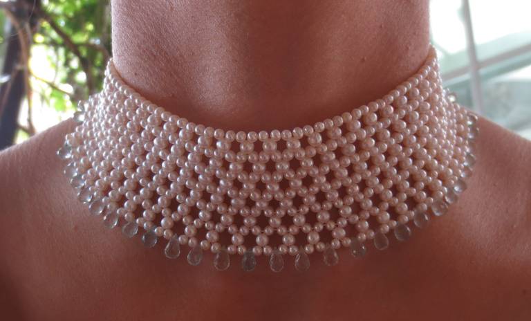 2.5 - 3mm cultured pearls are intricately hand woven to create a delicate lacelike design. Choker measures 13