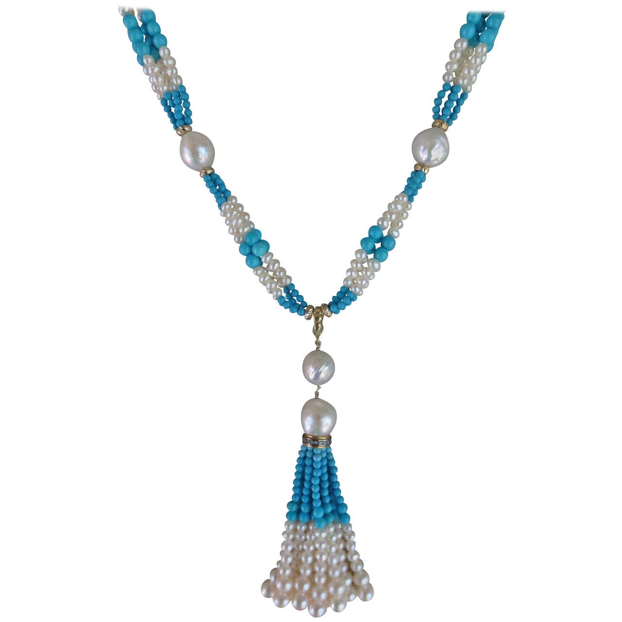 This elegant sautoir features slightly graduated white pearl and turquoise bead clusters between luxurious pearls, accented with 14k yellow gold beads and clasp. Each pearl is centered between 14 k yellow gold roundels. The 3-inch tassel hangs from