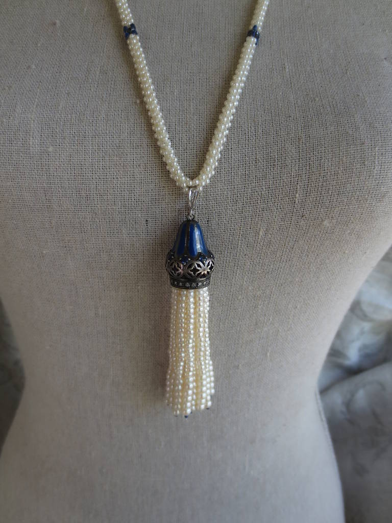 Woven into a rope-style lariat necklace with pearls and lapis-lazuli beads, this one-of-a-kind handmade piece may be worn with or without tassel, for versatility and variety.

The removable and unique tassel made of sterling silver, white gold,