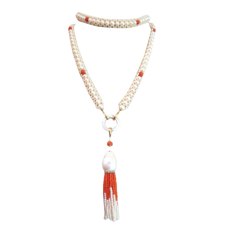 This stunning woven white pearl and coral necklace is beautifully balanced using 6 1/2 -7mm and 2 1/2 - 3mm white pearls and red coral beads, 14k yellow gold, and diamonds.  It measures 37 in long  (42 inches with tassel) and is accented with a gold