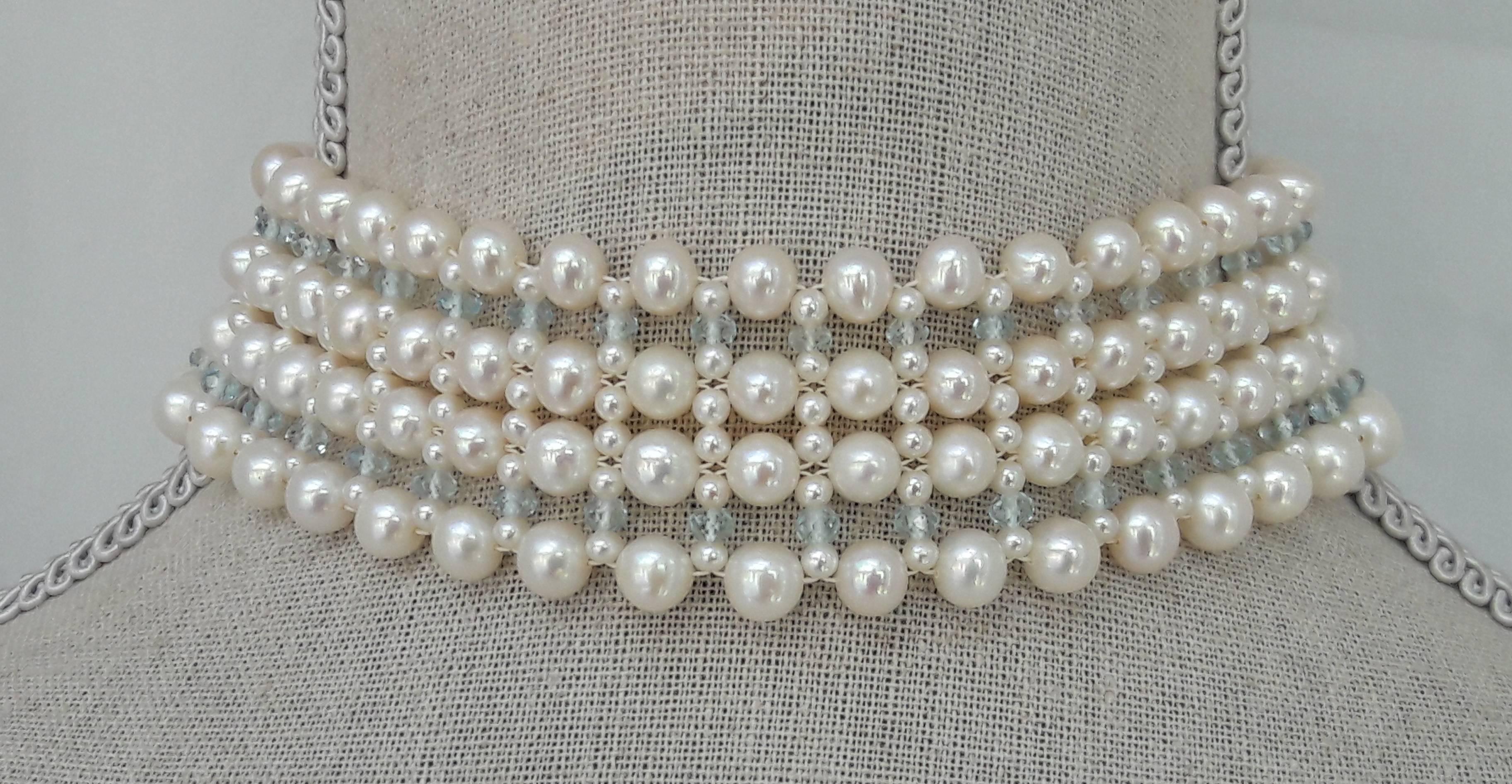 5-6mm white pearls, 2mm white pearls and 3mm aquamarine beads are woven in to a one of a kind choker. Secured with a 14 kt yellow gold sliding clasp. Strong, and at the same time very soft and manageable, this choker sits perfectly on the neck to