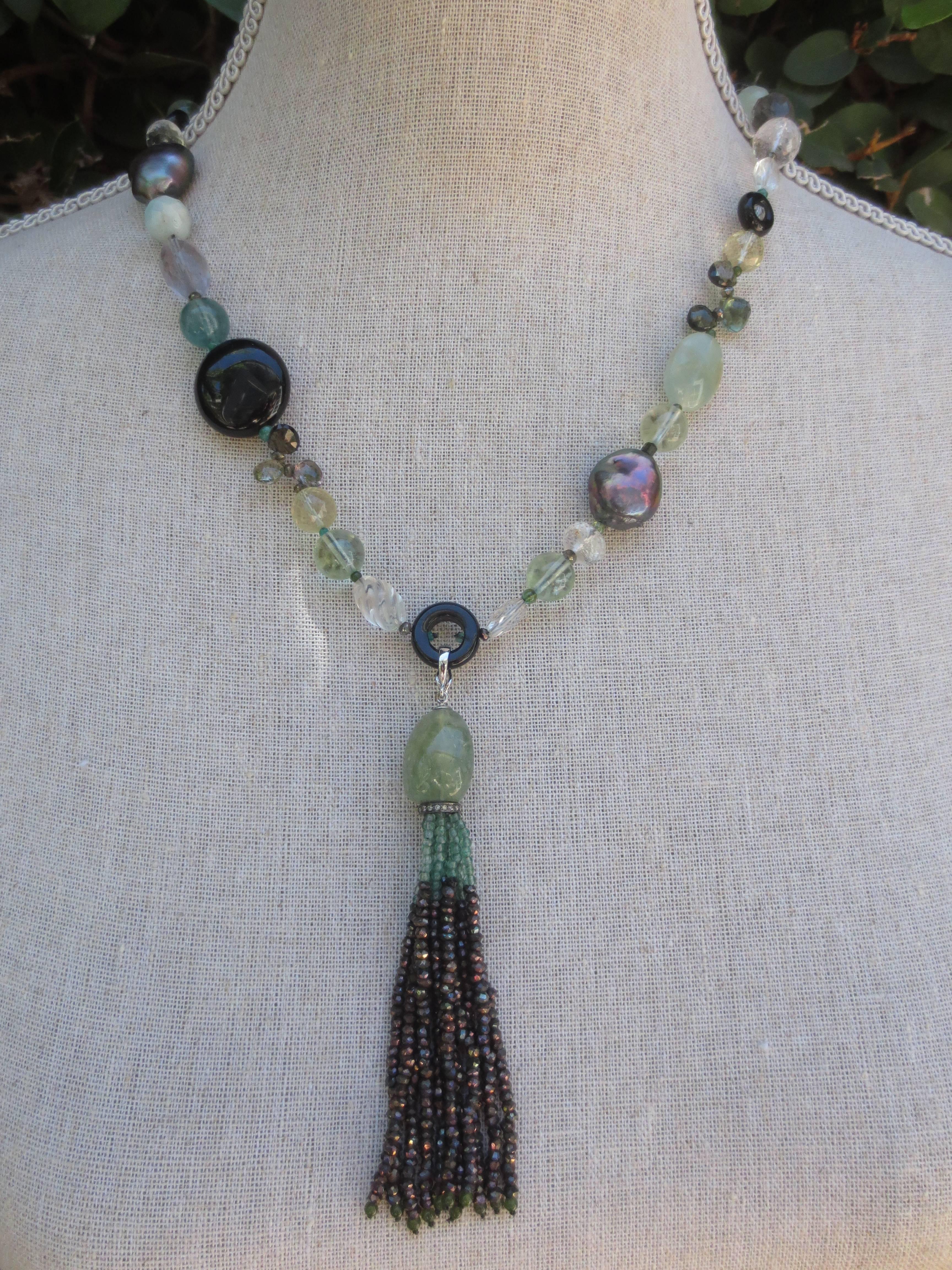 This gorgeous tassel sautoir necklace features green onyx, black pearls, , fluorite, citrine, green agate, black onyx, rose quartz, green tourmaline, morganite, emerald, and green amethyst beads. Each stone is specifically chosen to create a mixed