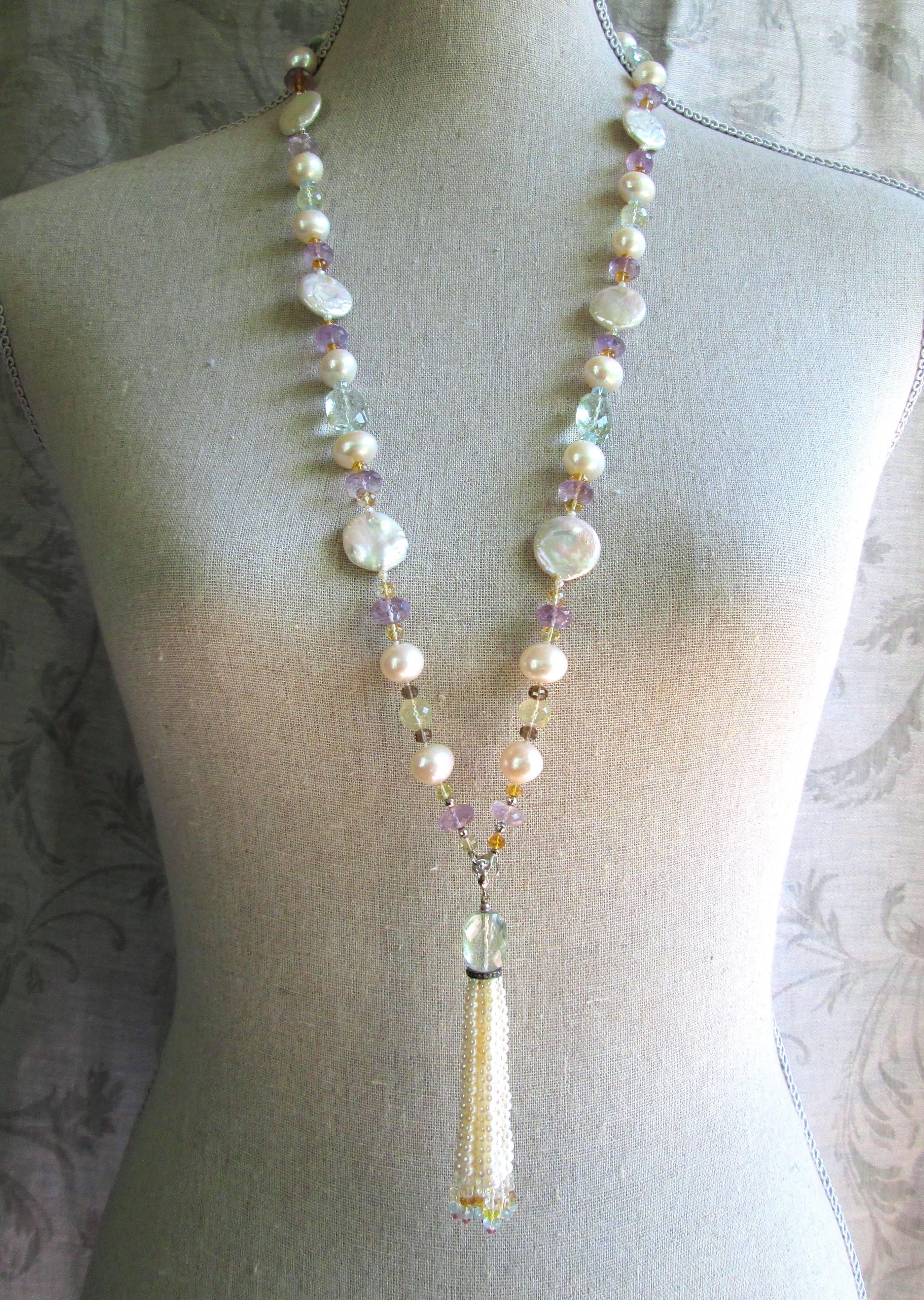 Large Baroque and flat-coin pearls are paired with Amethyst, Citrine, Topaz, Aquamarine, Green Garnet, and Fluorite beads to create a gorgeous shimmering piece. The semiprecious stones highlight the luster and iridescence of the pearls, unifying the