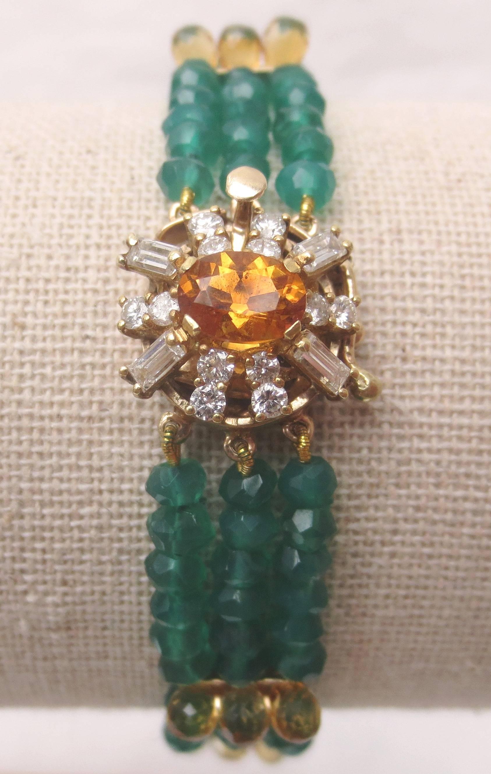 Mid-century diamond, citrine, and 14 k yellow gold clasp serve as the centerpiece for 3 strands of faceted green onyx beads and citrine briolettes. The citrine teardrops are set upright to create a contoured profile that stands out against the